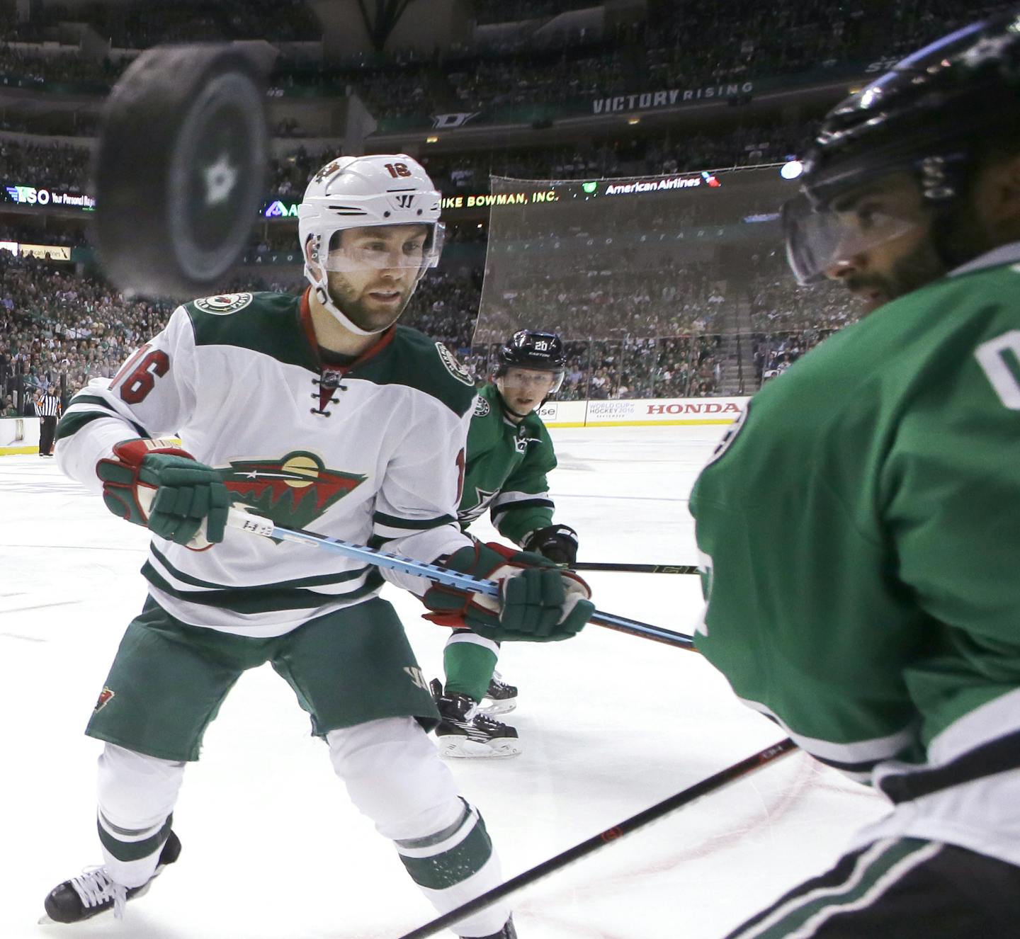 Minnesota Wild left wing Jason Zucker (16) and Dallas Stars defenseman Johnny Oduya (47) vie for control of the puck during the first period in Game 1 of a first-round NHL hockey Stanley Cup playoff series Thursday, April 14, 2016, in Dallas. (AP Photo/LM Otero) ORG XMIT: DNA105