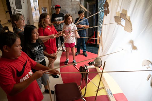 Campers use shadow puppets backstage for one of the time travel realms while in a dress rehearsal for their upcoming original show "Skyview: The One-Eyed Time Ride" part of Northern Lights Opera Company Kids Theatre Camp at Pine Point School on the White Earth Reservation.