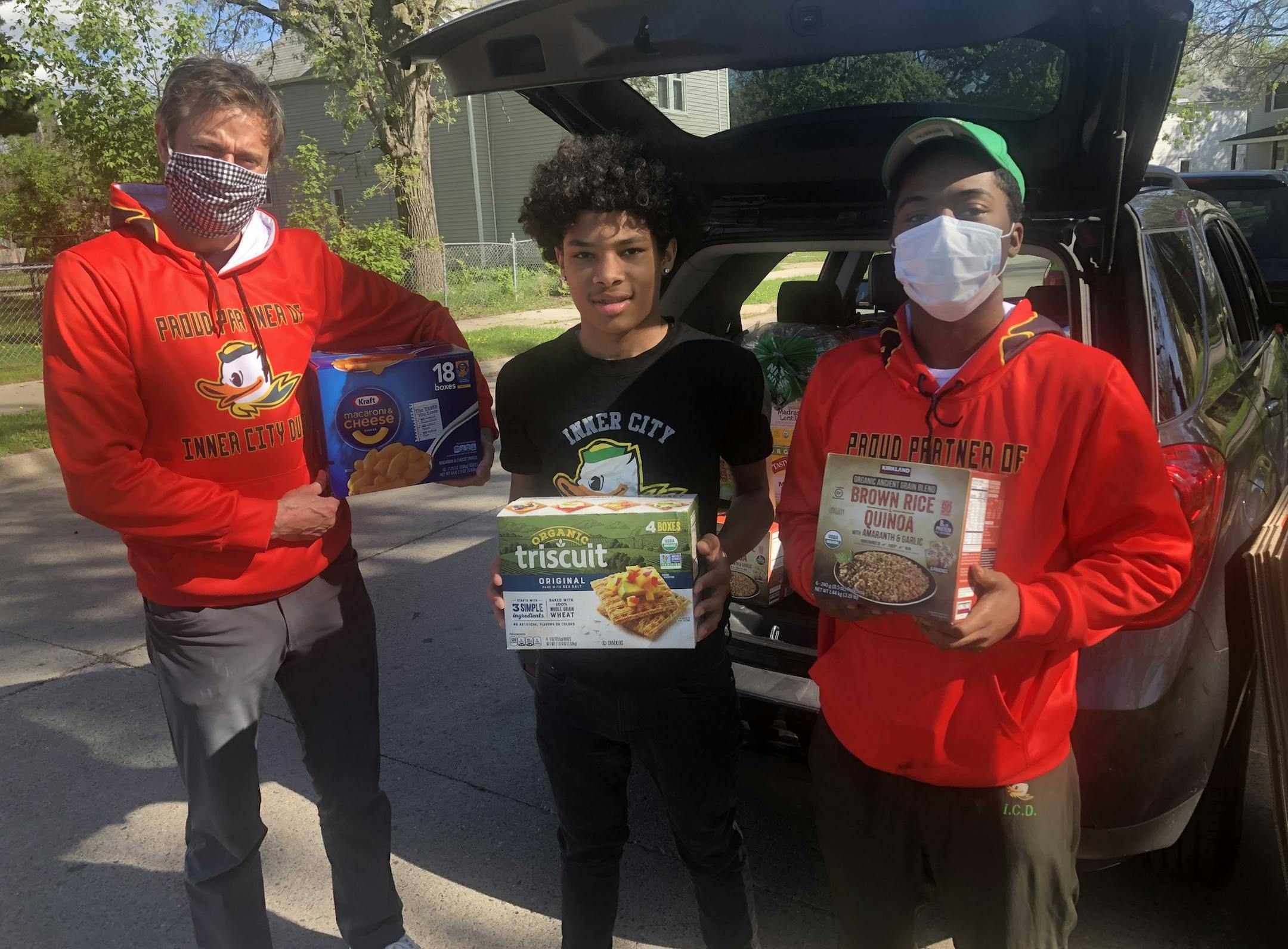 Don MacPherson, Dashon Amos and Shakeel Nelson of Inner City Ducks delivering groceries in May to Duck families in North Minneapolis. Photo:Neal.St.Anthony@startribune.com