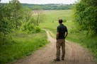 David Ruff, conservation program manager with the Nature Conservancy who helped acquire the land, looks out onto newly seeded prairie during a tour of