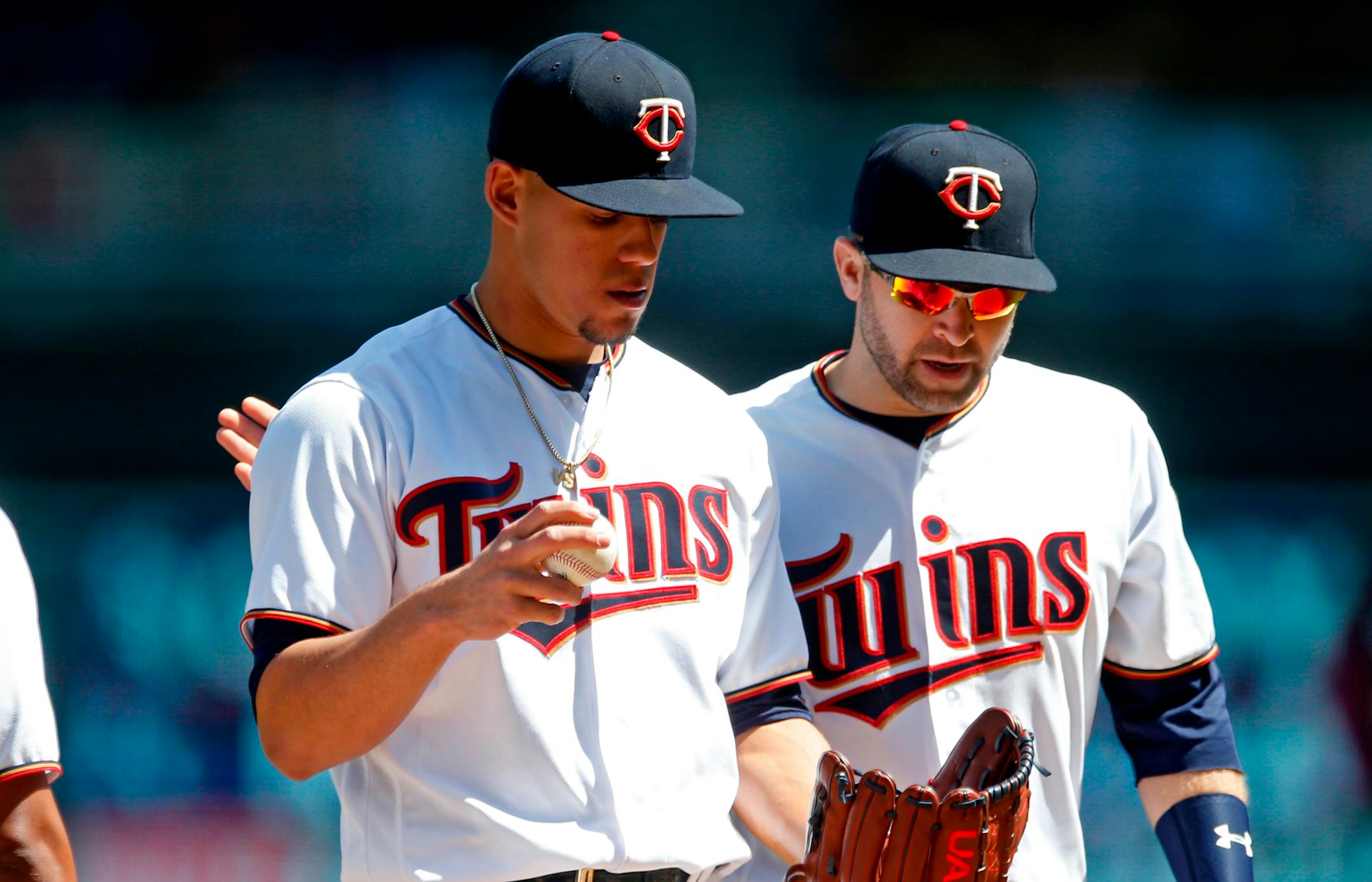 Twins starter Jose Berrios, left, got a pep talk from second baseman Brian Dozier in the third inning of Cincinnati's 8-2 victory at Target Field on Sunday.