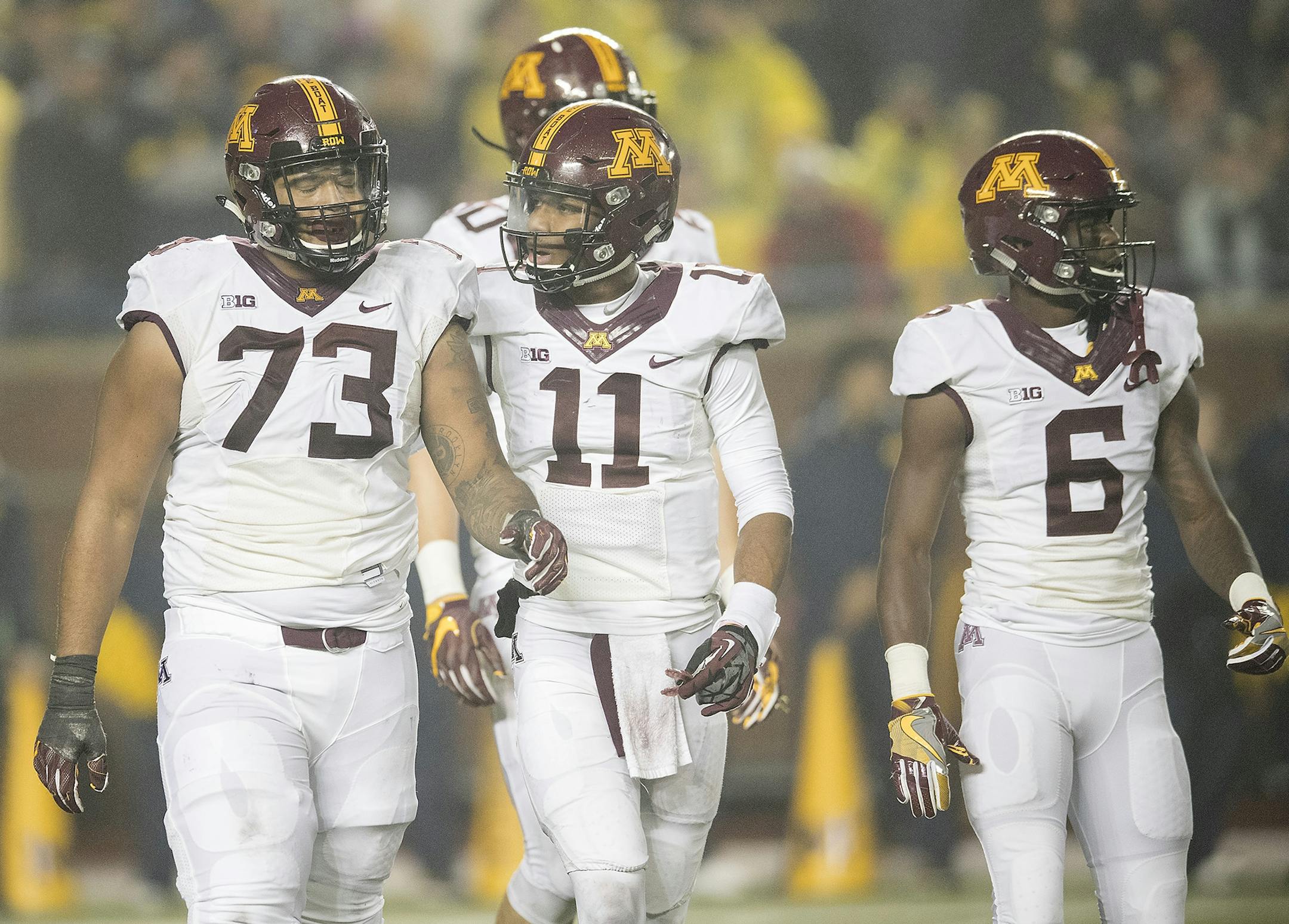 Minnesota's quarterback Demry Croft, center, walked off the field with offensive lineman Donnell Greene, left, as tempers flared during the fourth quarter the Gophers took on Michigan in Michigan Stadium, Saturday, November 4, 2017 in Ann Arbor, MI.
