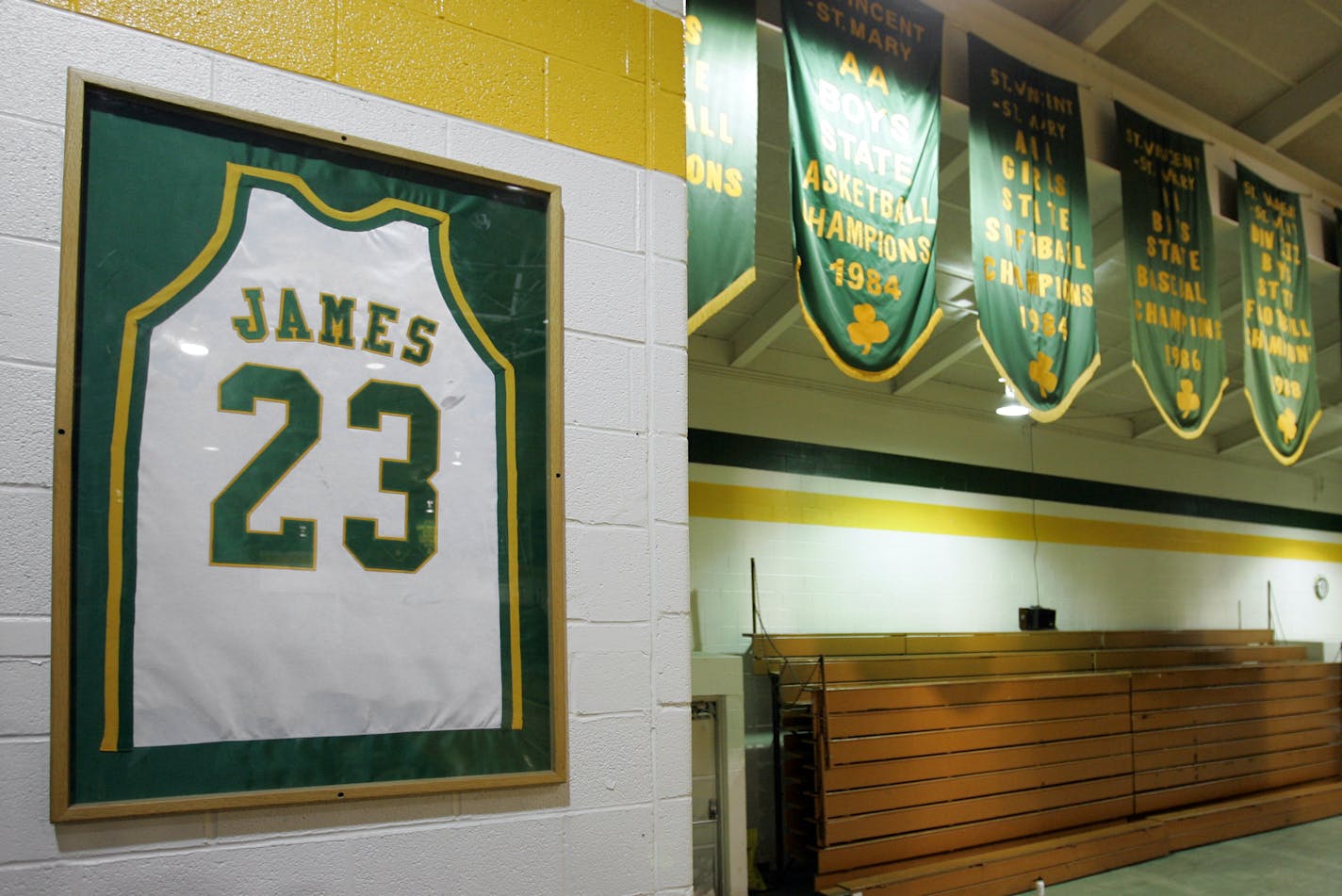 The retired jersey of LeBron James hangs in the gym at St. Vincent-St. Mary High School in Akron, Ohio next to the school's championship banners.