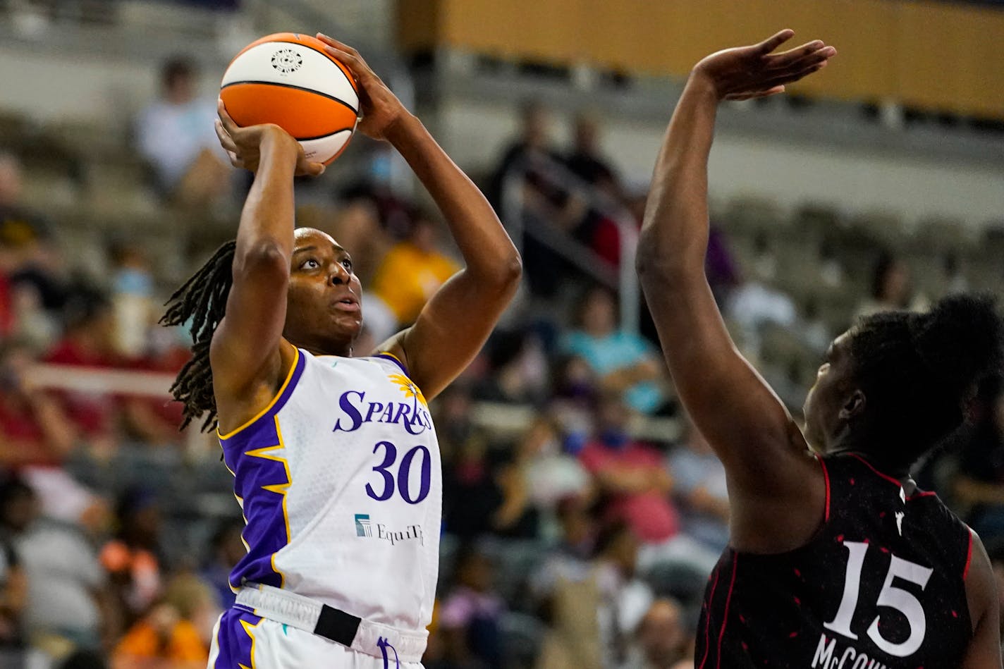 Los Angeles Sparks forward Nneka Ogwumike (30) shoots over Indiana Fever forward Teaira McCowan (15) in the first half of a WNBA basketball game in Indianapolis, Tuesday, Aug. 31, 2021. (AP Photo/Michael Conroy)