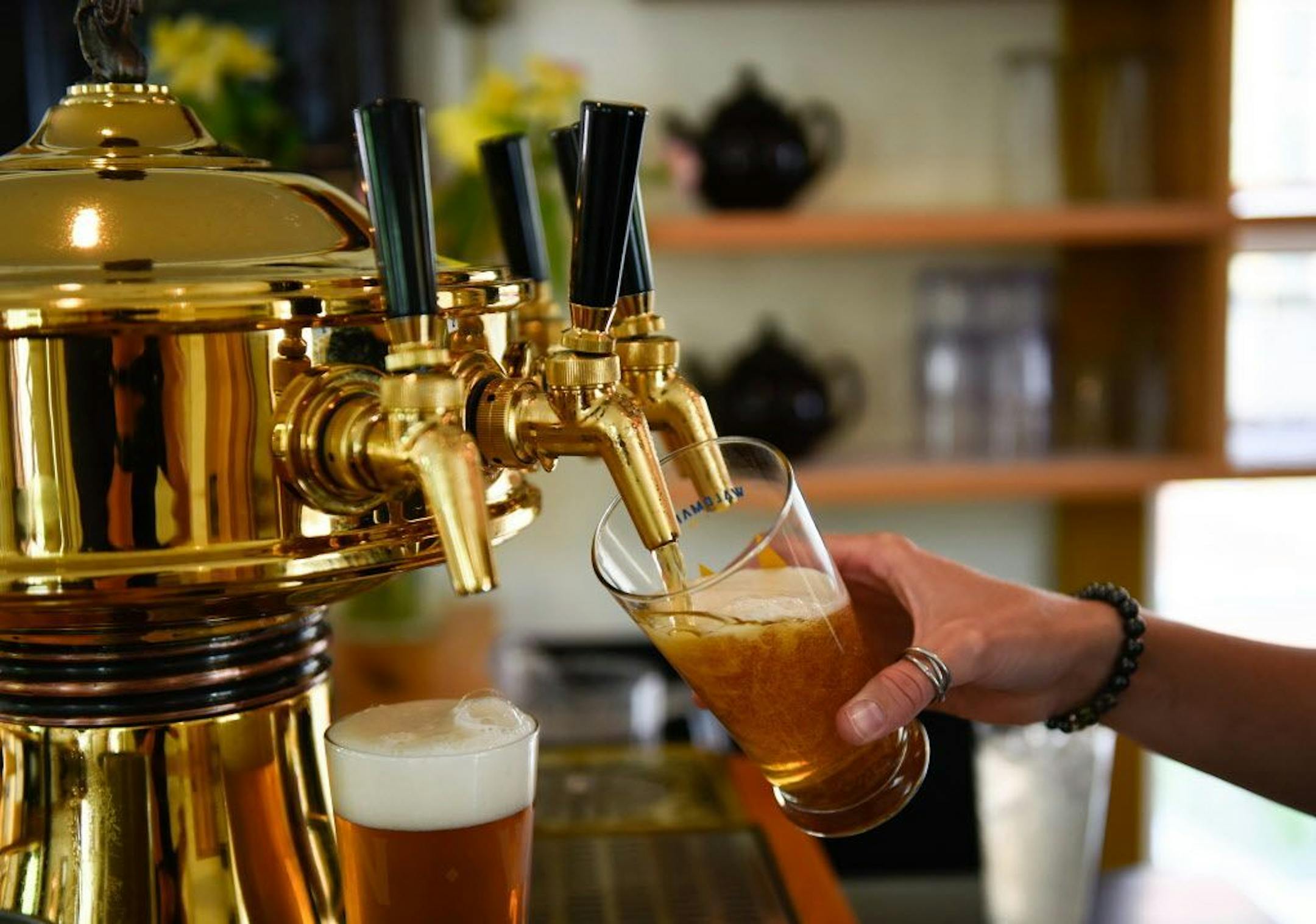 Waldmann Brewery server Kadyn Hutchinson poured a few pilseners for customers while working Friday afternoon.