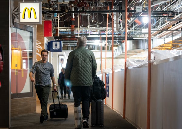 Passengers walk in Concourse D in Terminal 1, which is currently under renovation, at Minneapolis-St. Paul Airport on Thursday, Nov. 9, 2023. ] LEILA 
