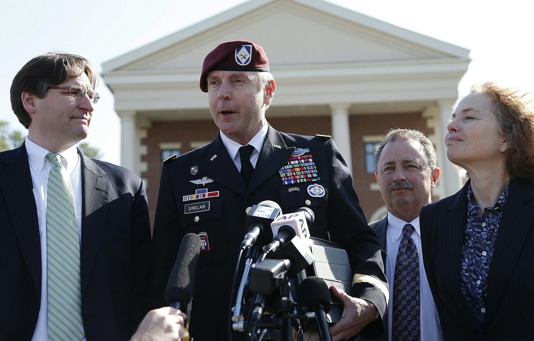 Brig. Gen. Jeffrey Sinclair, center, who admitted to inappropriate relationships with three subordinates, makes a statement after leaving the courthouse following sentencing at Fort Bragg, N.C., Thursday, March 20, 2014. Attorneys Lathrop Nelson III, left, Richard Scheff, and Ellen Brotman, right, look on. Sinclair was reprimanded and docked $20,000 in pay Thursday, avoiding jail time in one of the U.S. military's most closely watched courts-martial. (AP Photo/Ellen Ozier) ORG XMIT: MIN201403211