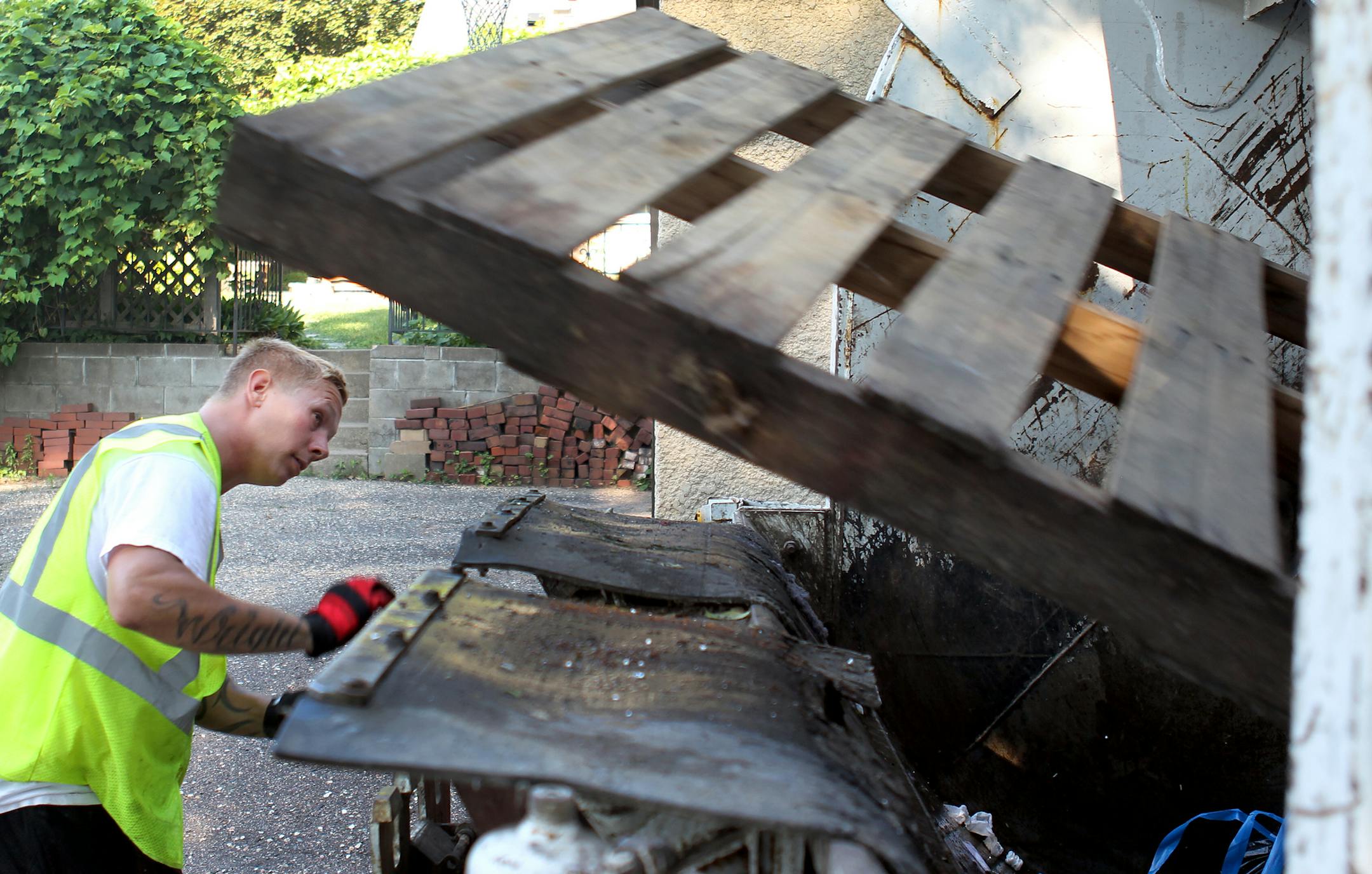 Alan Wright, of Charlie Hall Disposal Inc., collected trash in Minneapolis on Monday. The family-run business is part of a consortium hauling trash for the city.