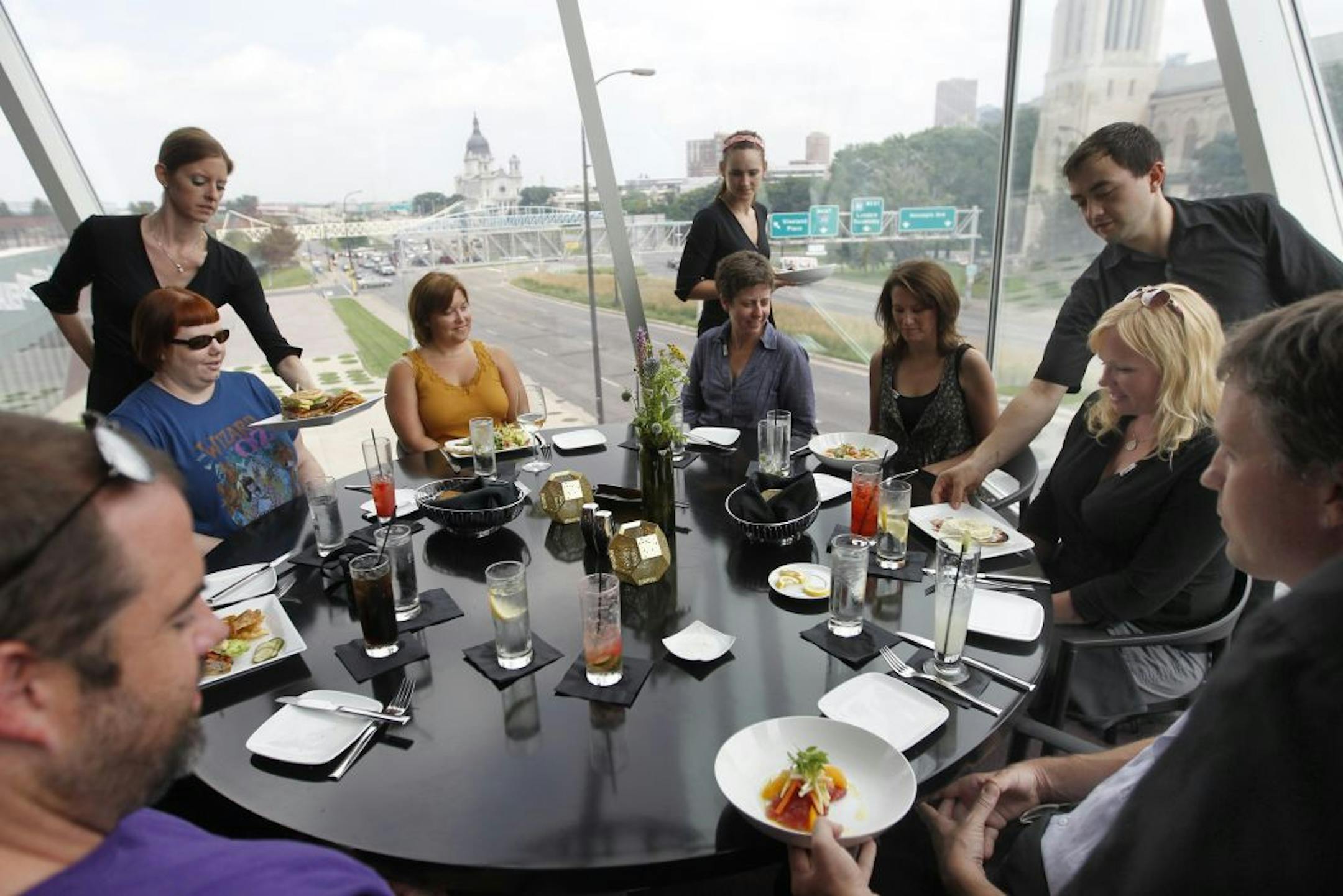 Gather, the new restaurant at the Walker, still has the iconic window table for larger groups. The place is only open for lunch at this point. The online book group from around the country had lunch before leaving Minnesota.__Assignments #20019141A_ August 5, 2011_ SLUG: rn0811_ EXTRA INFORMATION: Josh(CQ)Brown__ Restaurant review of Gather, the new restaurant in the former 20.21 space at the Walker. Chef Josh Brown, Vegetable salad, wild salmon, sweet pea agnolotti, goat cheese Panna cotta.