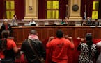 Immigrant rights activists chanted and held signs at the start of the Minneapolis City Council meeting to draw attention to a 13-point "Sanctuary Plat