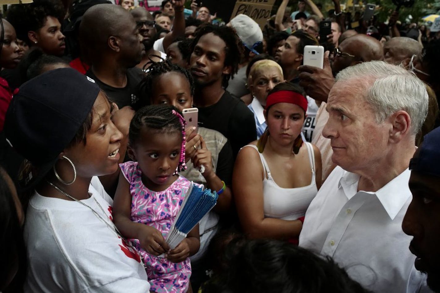 Gov. Mark Dayton met Thursday night with Castile family members, including Diamond Reynolds and her daughter, far left, outside his residence in St. Paul.