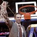 Minnesota coach Richard Pitino holds up the net after Minnesota defeated SMU 65-63 in an NCAA college basketball game in the final of the NIT, Thursda