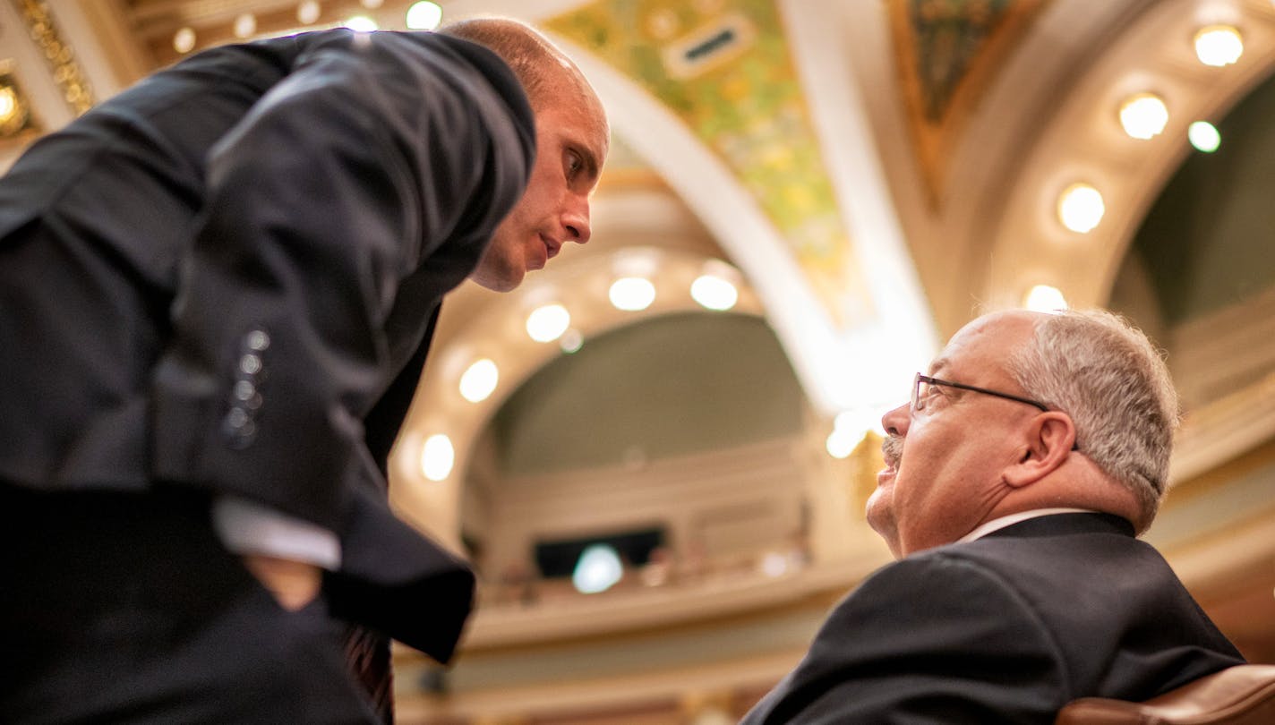 Rep. Gregory Davids conferred with tax committee administrator Stephen Rubis just before his bill passed 90-38.