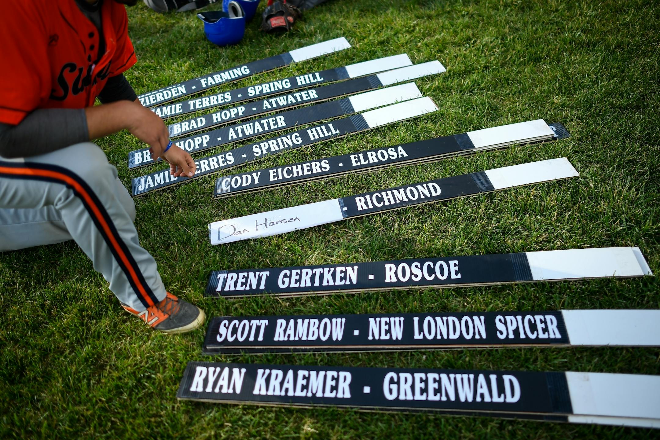 Elrosa catcher Cody Eichers set up a board with the names and team affiliations of competitors taking part in a Stearns County home run derby between the Stearns County League and the County Line League on Friday, June 30, 2017 in Elrosa, Minn.