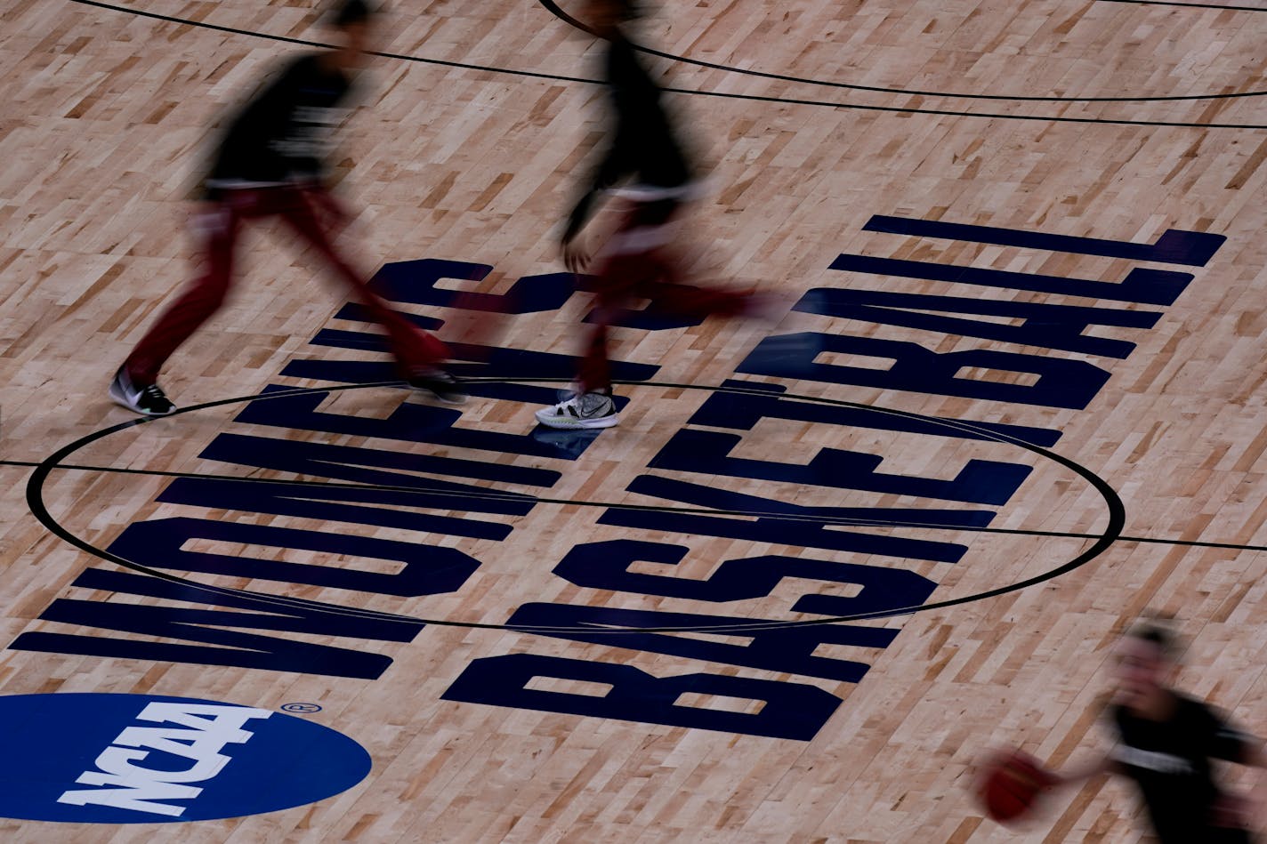 Stanford players, top, and a Utah Valley player warm up before their college basketball game in the first round of the women's NCAA tournament at the Alamodome in San Antonio, Sunday, March 21, 2021. (AP Photo/Charlie Riedel)