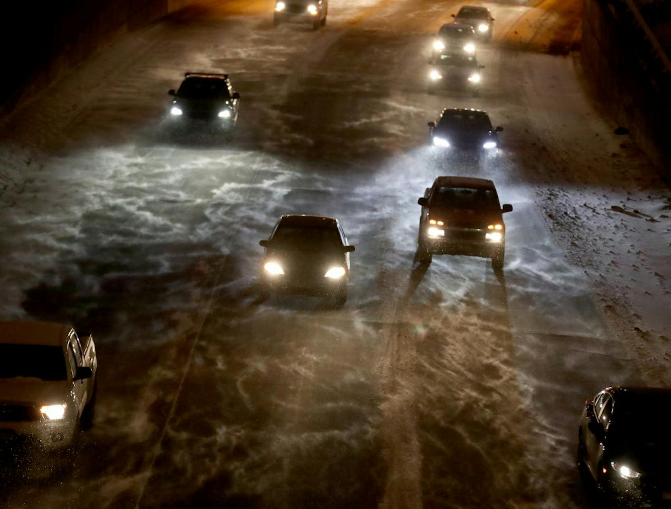 Motorists dealt with new snow and blowing winds while navigating I-94 during the morning commute, seen from the Franklin Avenue Bridge, Wednesday, Jan. 11, 2016, in Minneapolis, MN.