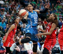 The Minnesota Lynx Maya Moore (23) splits Washington Mystic defenders Taylor Hill, left, and Alexis Jones while driving for a basket during the first 