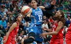 The Minnesota Lynx Maya Moore (23) splits Washington Mystic defenders Taylor Hill, left, and Alexis Jones while driving for a basket during the first 