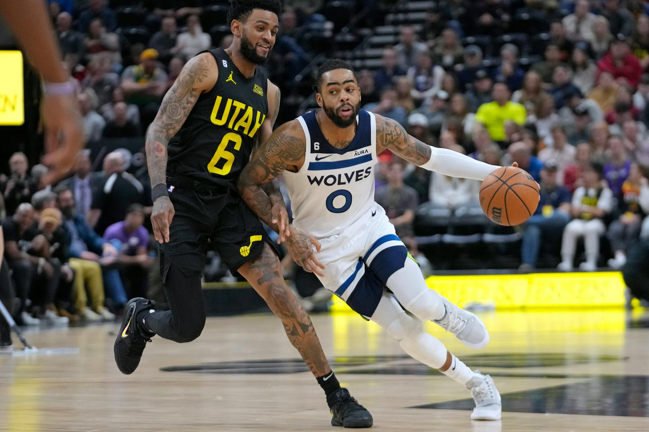 Utah Jazz guard Nickeil Alexander-Walker (6) guards Minnesota Timberwolves guard D'Angelo Russell (0) during the first half of an NBA basketball game Friday, Dec. 9, 2022, in Salt Lake City. (AP Photo/Rick Bowmer)