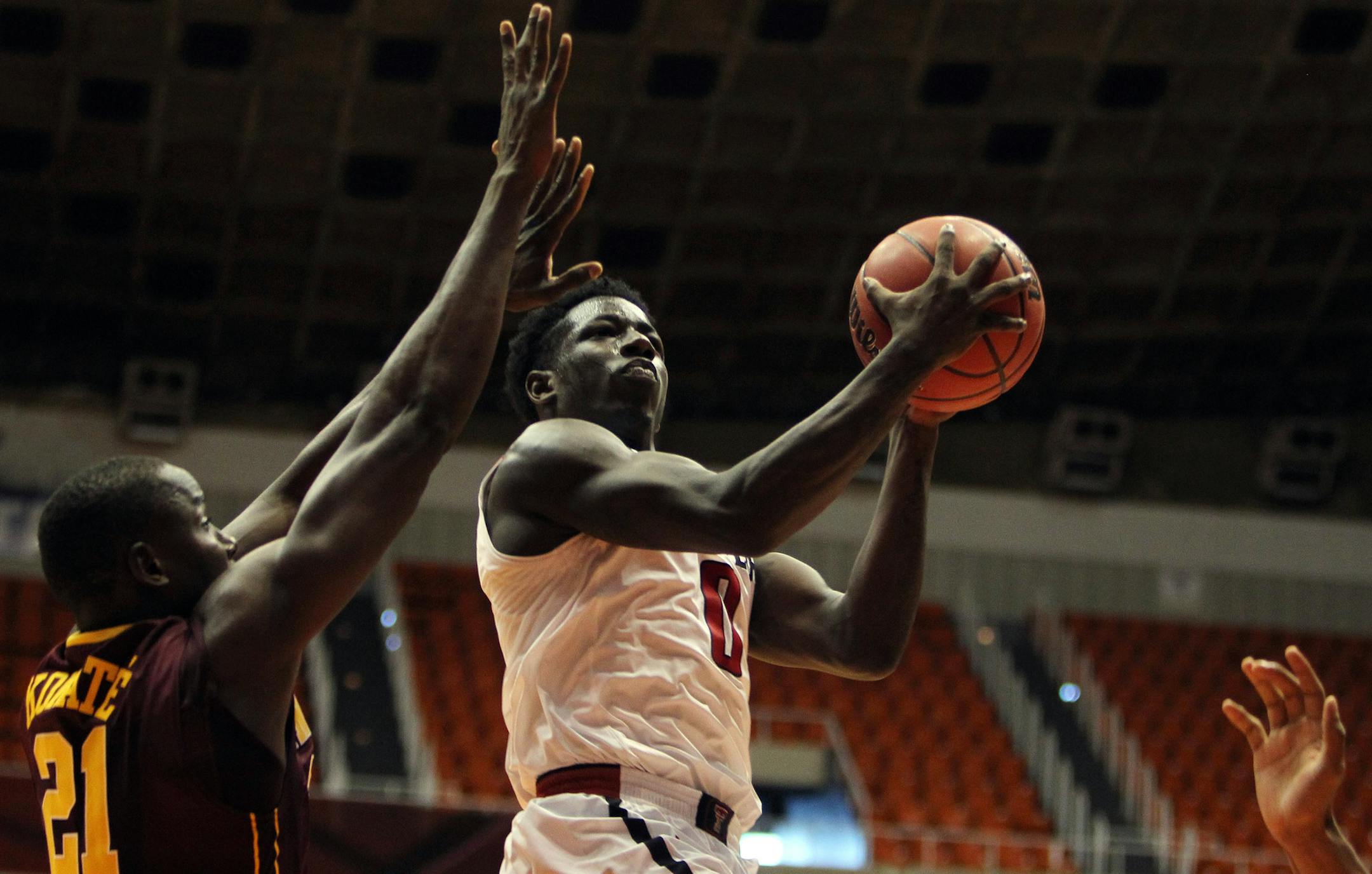 Texas Tech guard Devaugntah Williams, right, goes to the basket against Minnesota center Bakary Konate during the Puerto Rico Tip-Off college basketball tournament in San Juan, Sunday, Nov. 22, 2015. (AP Photo/Ricardo Arduengo)