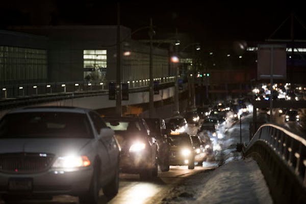 Cars line up to enter the departure area of Minneapolis-St. Paul Airport's Terminal 1.