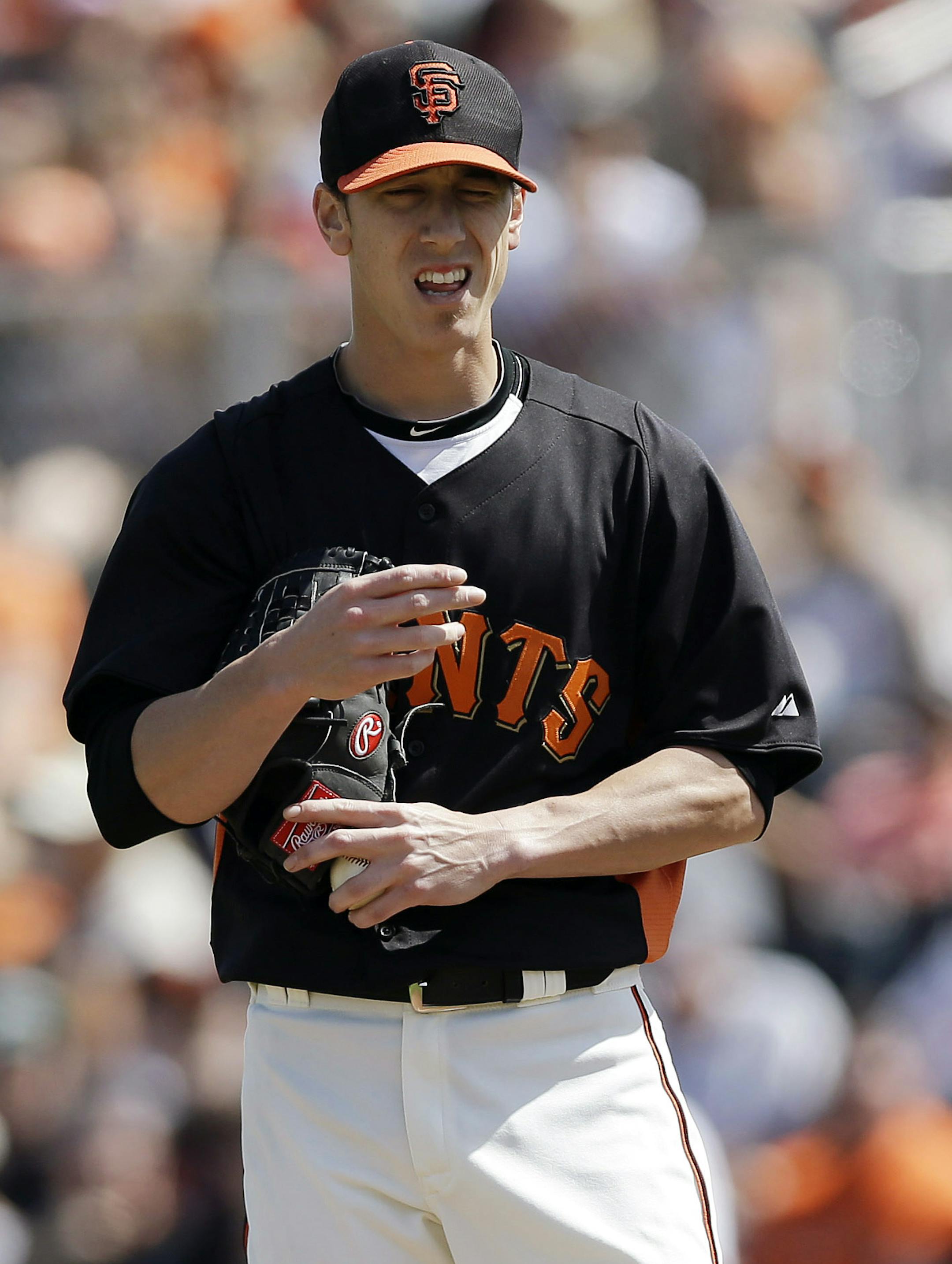 San Francisco Giants starting pitcher Tim Lincecum reacts after walking Oakland Athletics' Daric Barton during the second inning of an exhibition spring training baseball game on Saturday, March 23, 2013 in Scottsdale, Ariz. (AP Photo/Marcio Jose Sanchez)