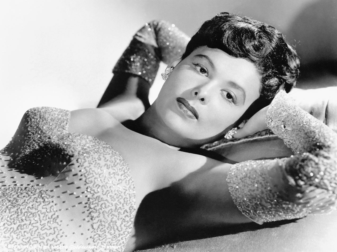 Lena Horne, prominent singer of jazz who is also an actress, poses in a sequined gown.