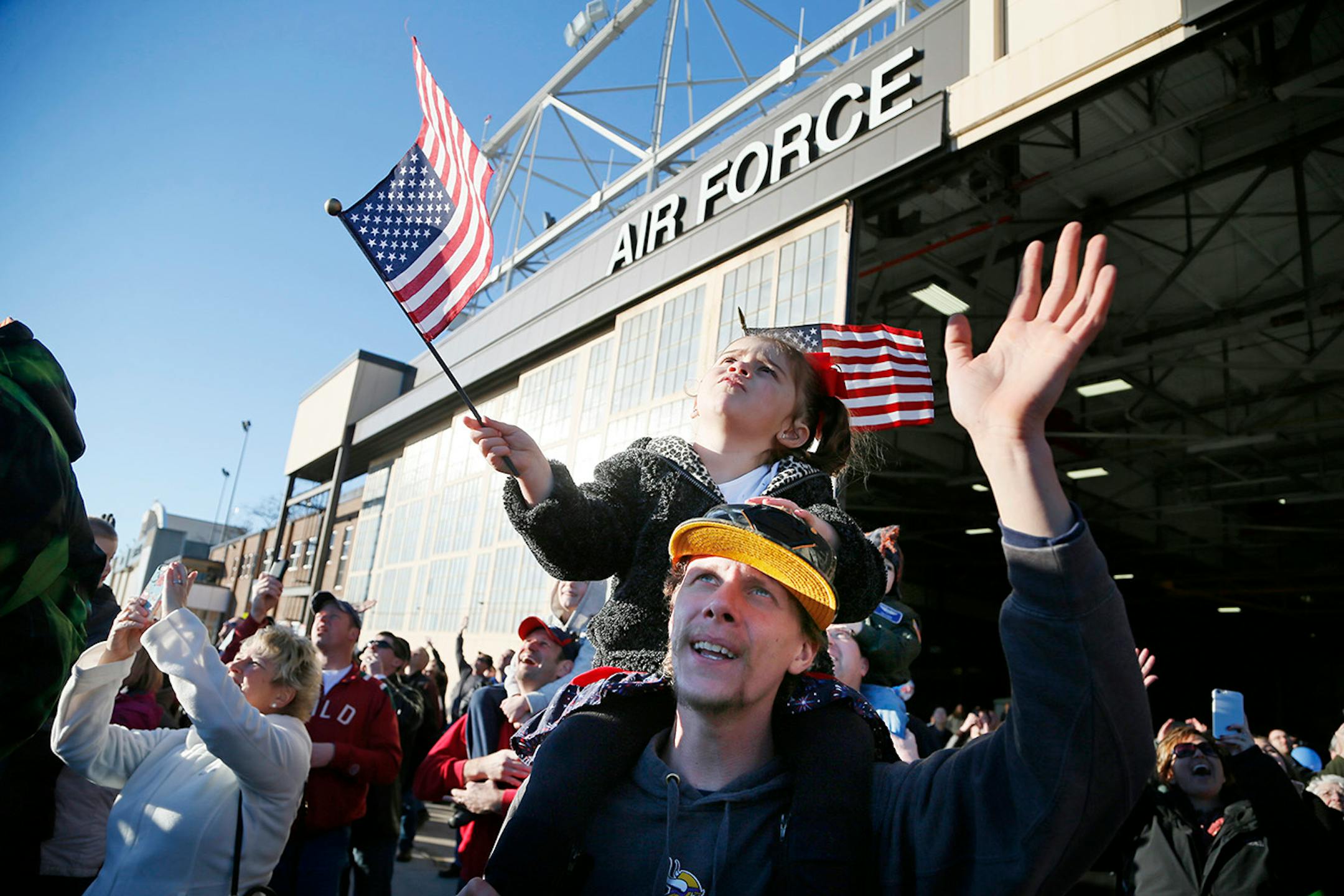 Judah Leier held his 3-year old daughter Aubree Leier on his shoulders, they were waving to her uncle Benjamin Rettmann who returned home Sunday. Families gather for the arrival of the more than 100 Airmen and three C-130 H3 Hercules aircraft from the 934th Airlift Wing, Air Force Reserve, return from their deployment to Southwest Asia after their four-month tour of duty. Sunday January 18, 2015 Minneapolis, MN.] Jerry Holt/ Jerry.Holt@Startribune.com