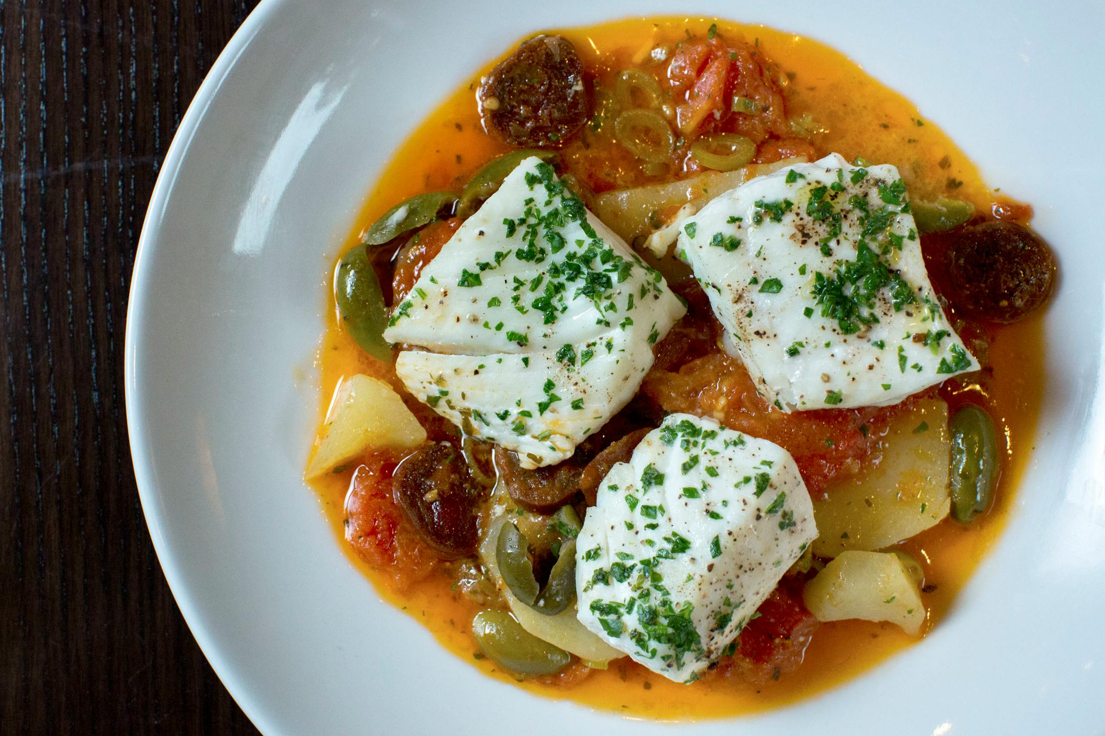 Lovechild serves halibut baked with tomatoes, chorizo and potatoes. ] COURTNEY PEDROZA • courtney.pedroza@startribune.com June 22-24, 2017; Wisconsin restaurants, cafes, bars, bakeries and breweries; Dining along the Mississippi River.