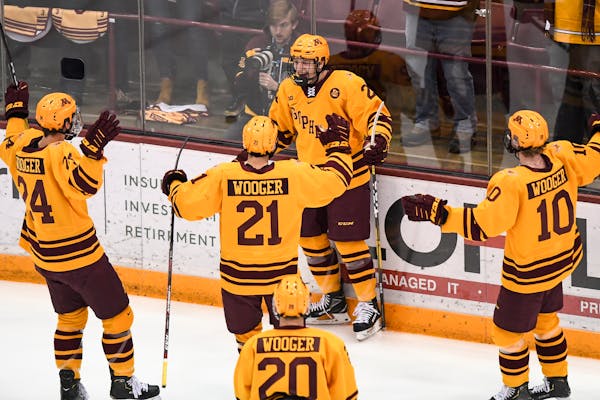 Teammates celebrated with Gophers forward Bryce Brodzinski (22) after his first period goal against Ohio State on Jan. 25