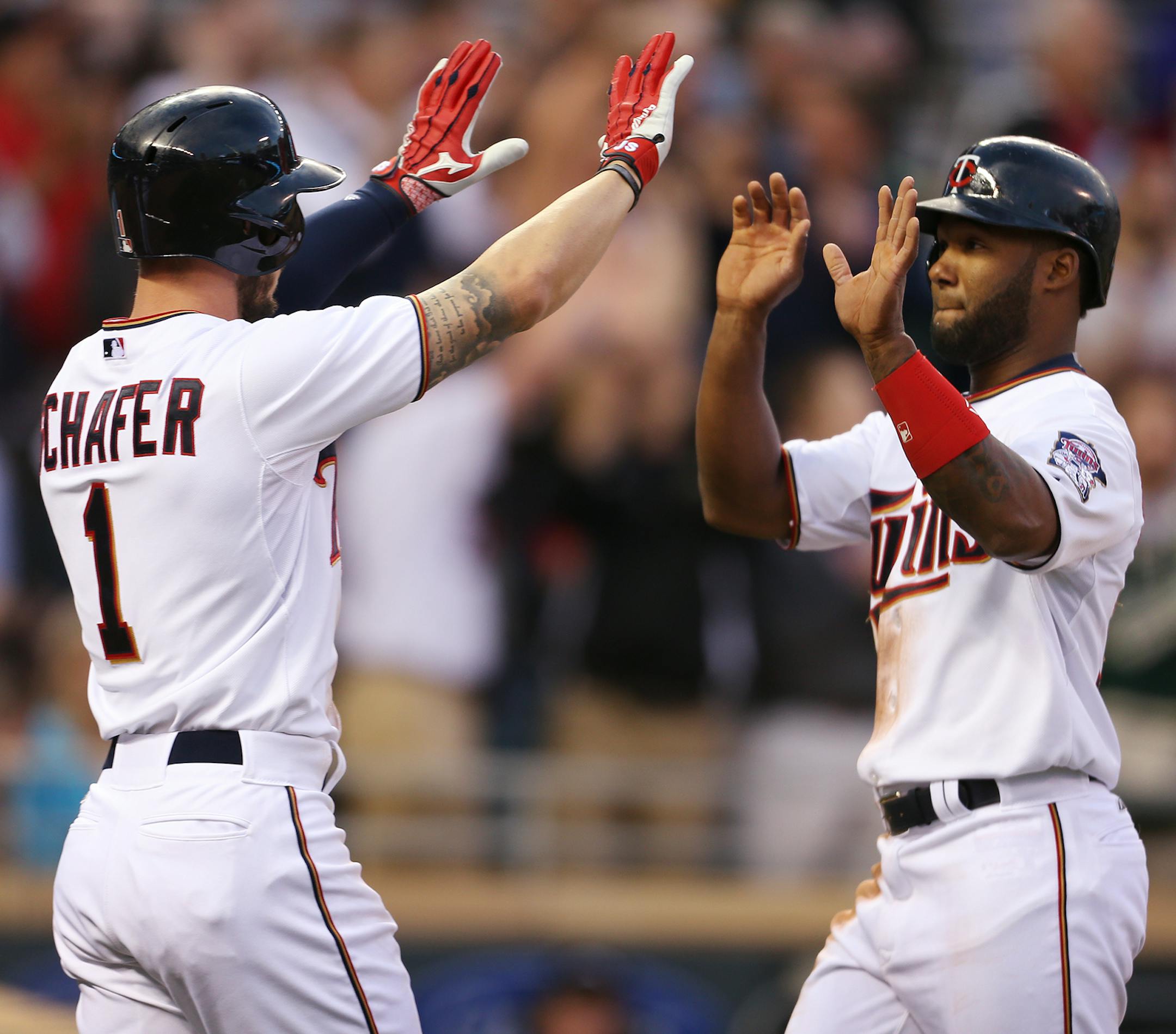 Jordan Schafer, left, and Danny Santana of the Twins celebrate scoring in the second inning against the Oakland Athletics at Target Field in Minneapolis on Monday, May 4, 2015. ] LEILA NAVIDI leila.navidi@startribune.com /