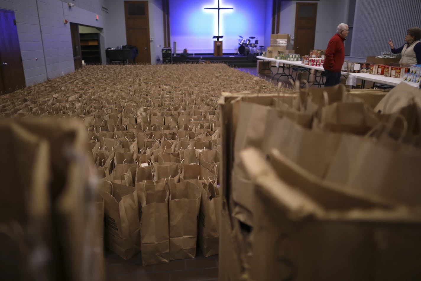 Some of the thousands of grocery bags packed by volunteers at the Union Gospel Mission, each containing all the fixings, that when combined with the turkeys also distributed, make a complete Thanksgiving meal. ] JEFF WHEELER &#xef; jeff.wheeler@startribune.com Volunteers were packing and distributing Thanksgiving meal components at the Union Gospel Mission in St. Paul Monday evening, November 20, 2016. Christy Vasquez, who has received the Thanksgiving grocery bag herself in the past, has been v