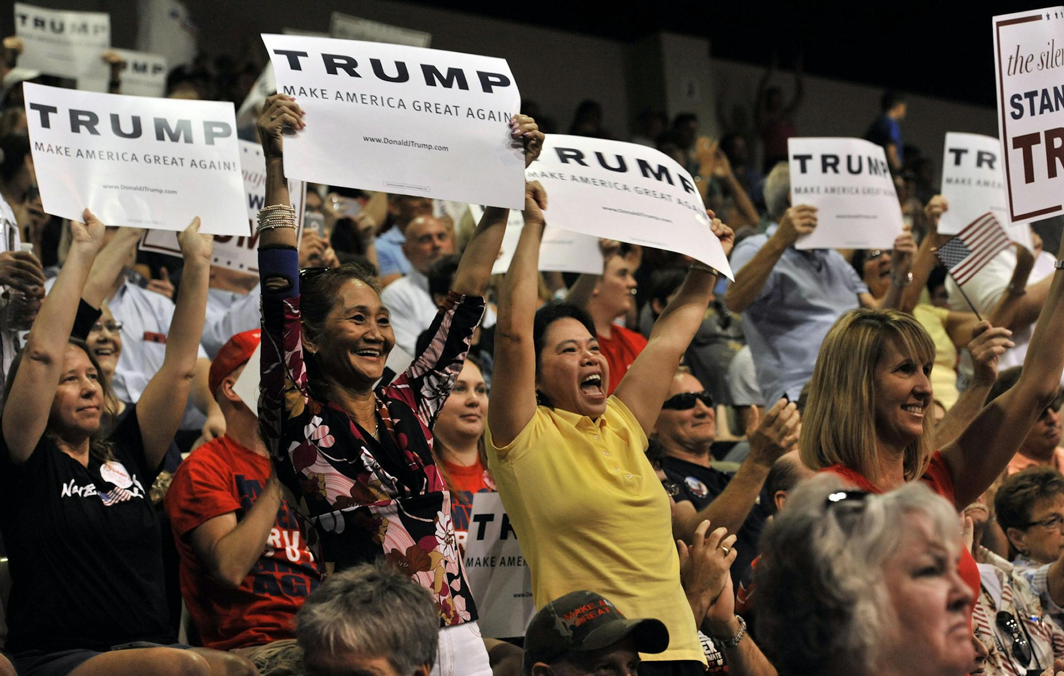 Supporters of Republican presidential candidate Donald Trump cheer during a campaign rally Saturday, Nov. 28, 2015 at Robarts Arena in Sarasota, Fla. Speaking before thousands who jammed into the arena, Trump said he's "killing everybody" in polls nationally and in early voting states. (AP Photo/Steve Nesius) ORG XMIT: MIN2015120112474421