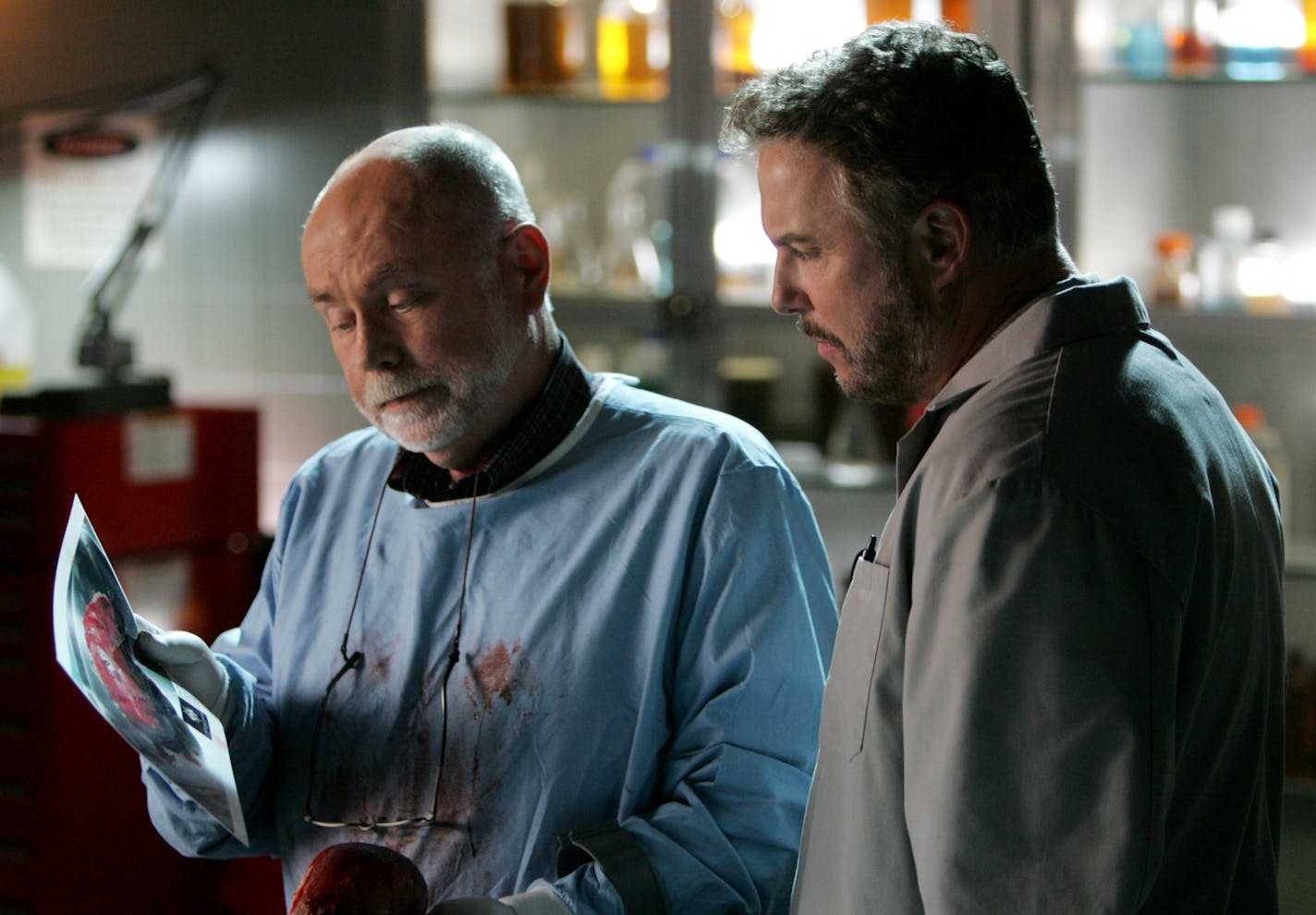 Shows such as &#x201c;CSI: Crime Scene Investigation&#x201d; and characters such as Dr. Robbins, played by Robert David Hall, left, have given a rise in interest in the medical examiner profession.