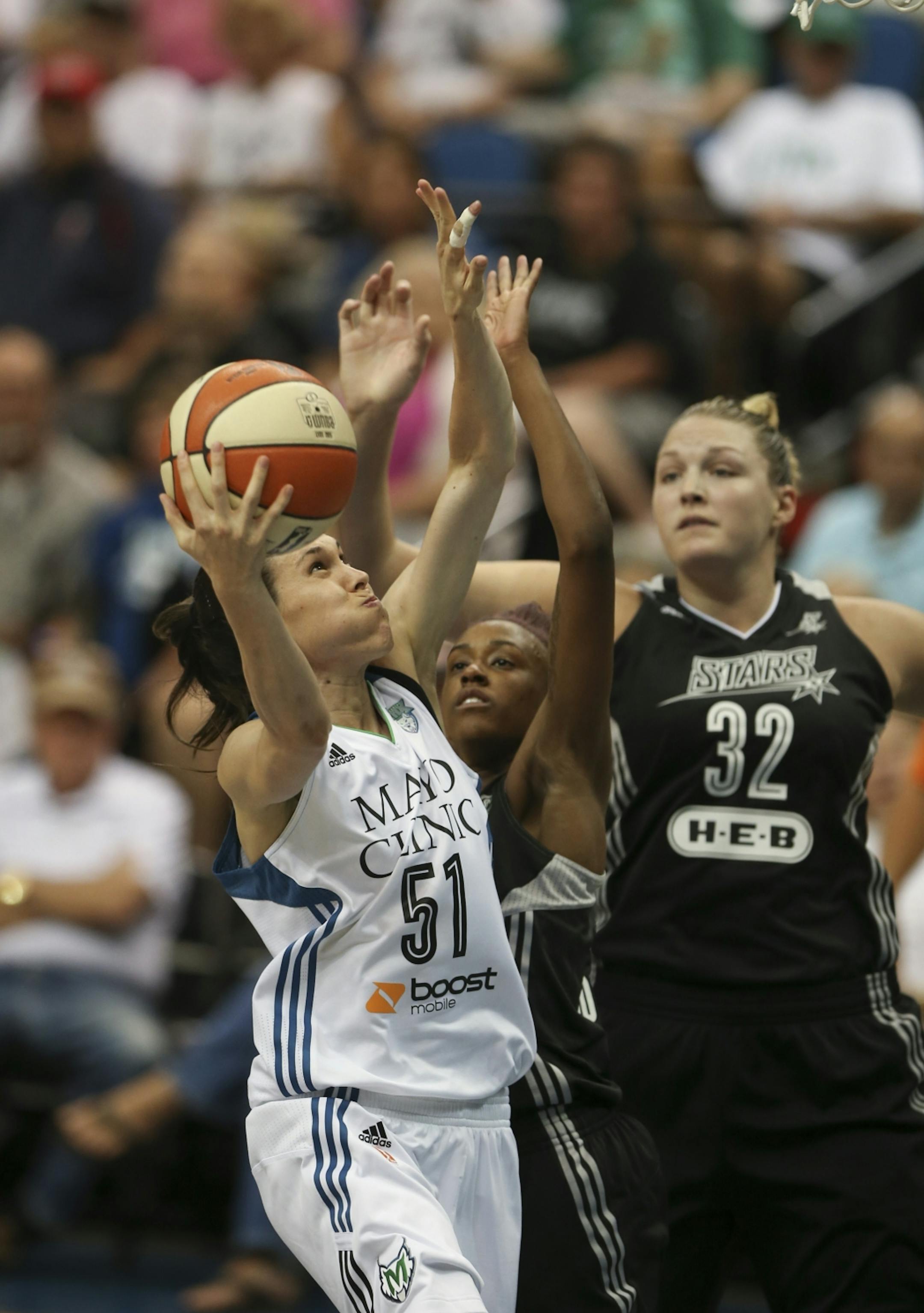 The Lynx' Anna Cruz put up a first quarter basket while defended by the Stars' Danielle Robinson and Jayne Appel (32) Sunday night at Target Center. JEFF WHEELER � jeff.wheeler@startribune.com The Minnesota Lynx met the San Antonio Stars in an WNBA game Sunday night, July 12, 2015 at Target Center in Minneapolis.