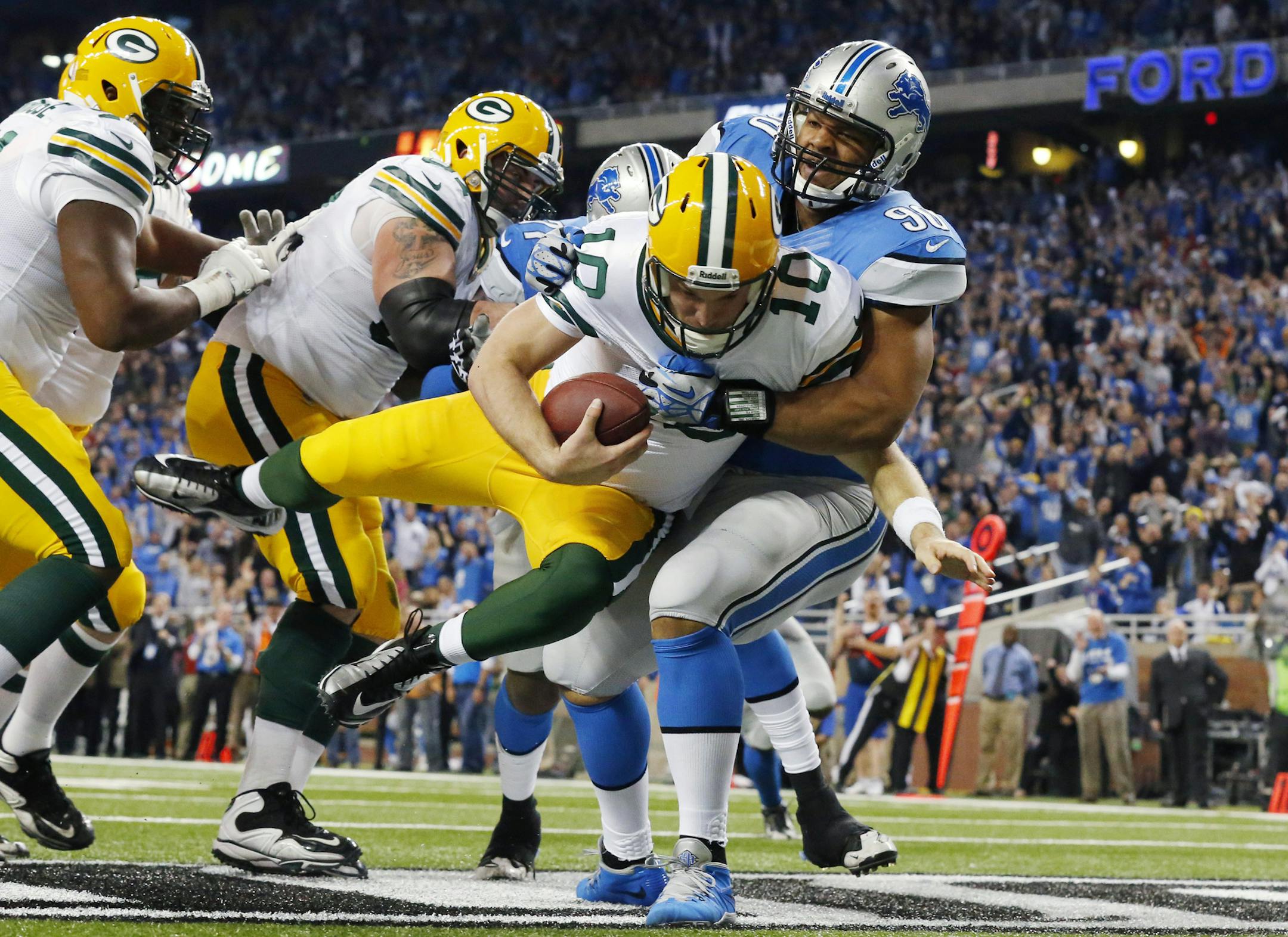 Detroit Lions defensive tackle Ndamukong Suh (90) sacks Green Bay Packers quarterback Matt Flynn for a safety during the third quarter of an NFL football game at Ford Field in Detroit, Thursday, Nov. 28, 2013. (AP Photo/Paul Sancya)