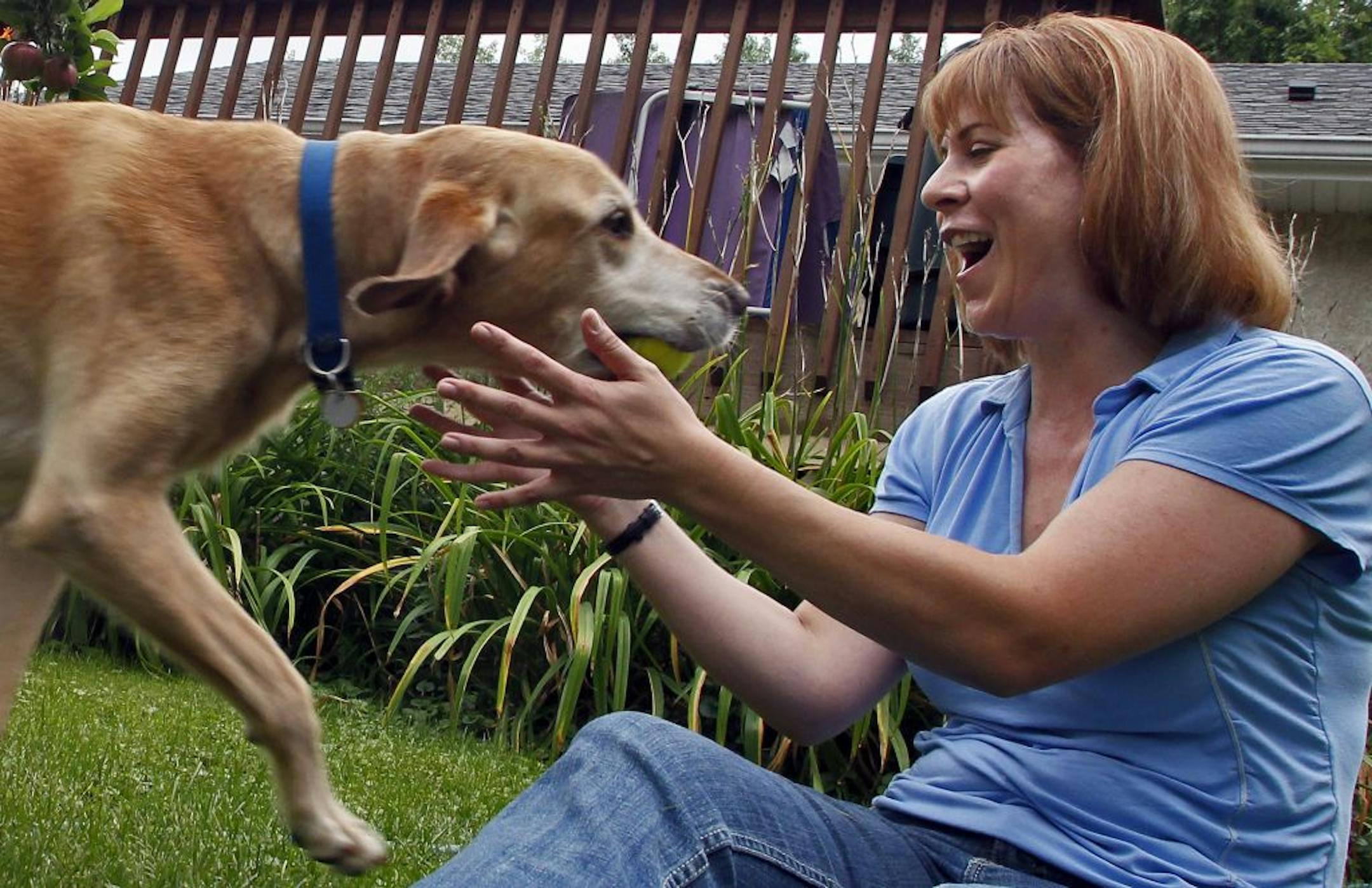 Beth Styrbicki with her golden lab retriever Sweet Louie.