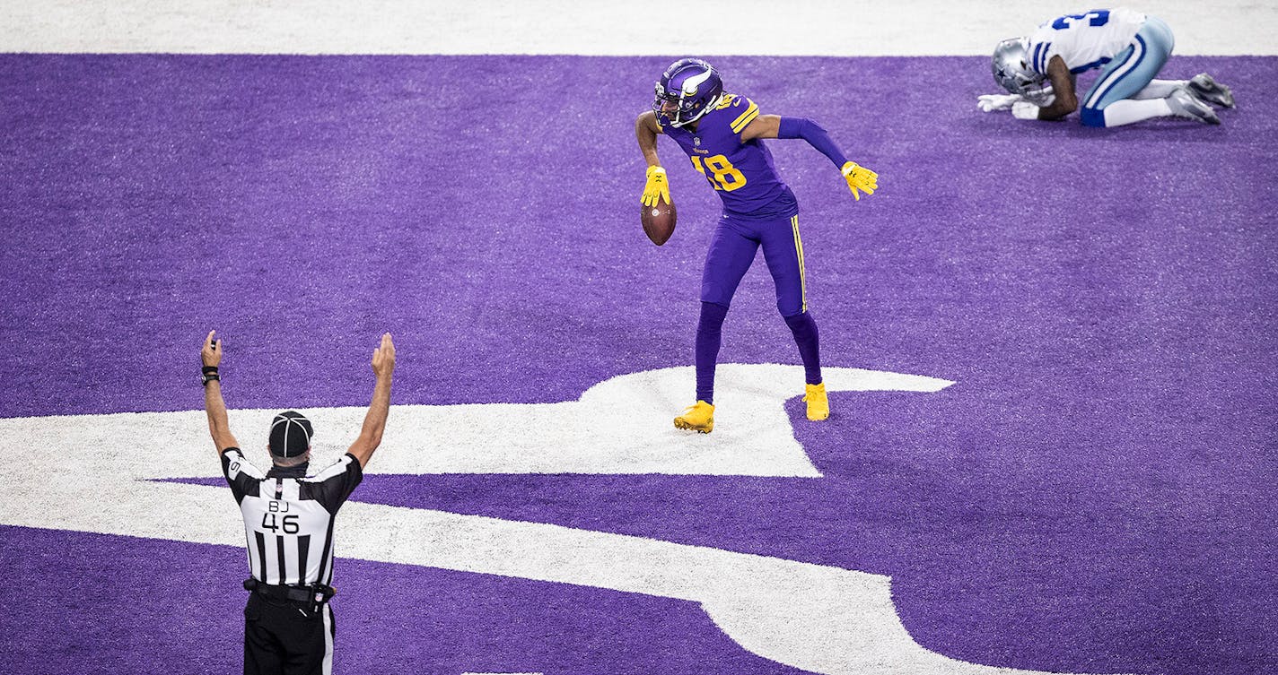 Minnesota Vikings wide receiver Justin Jefferson (18) celebrates his 4th quarter touchdown as Dallas Cowboys cornerback Anthony Brown (30) could not watch.