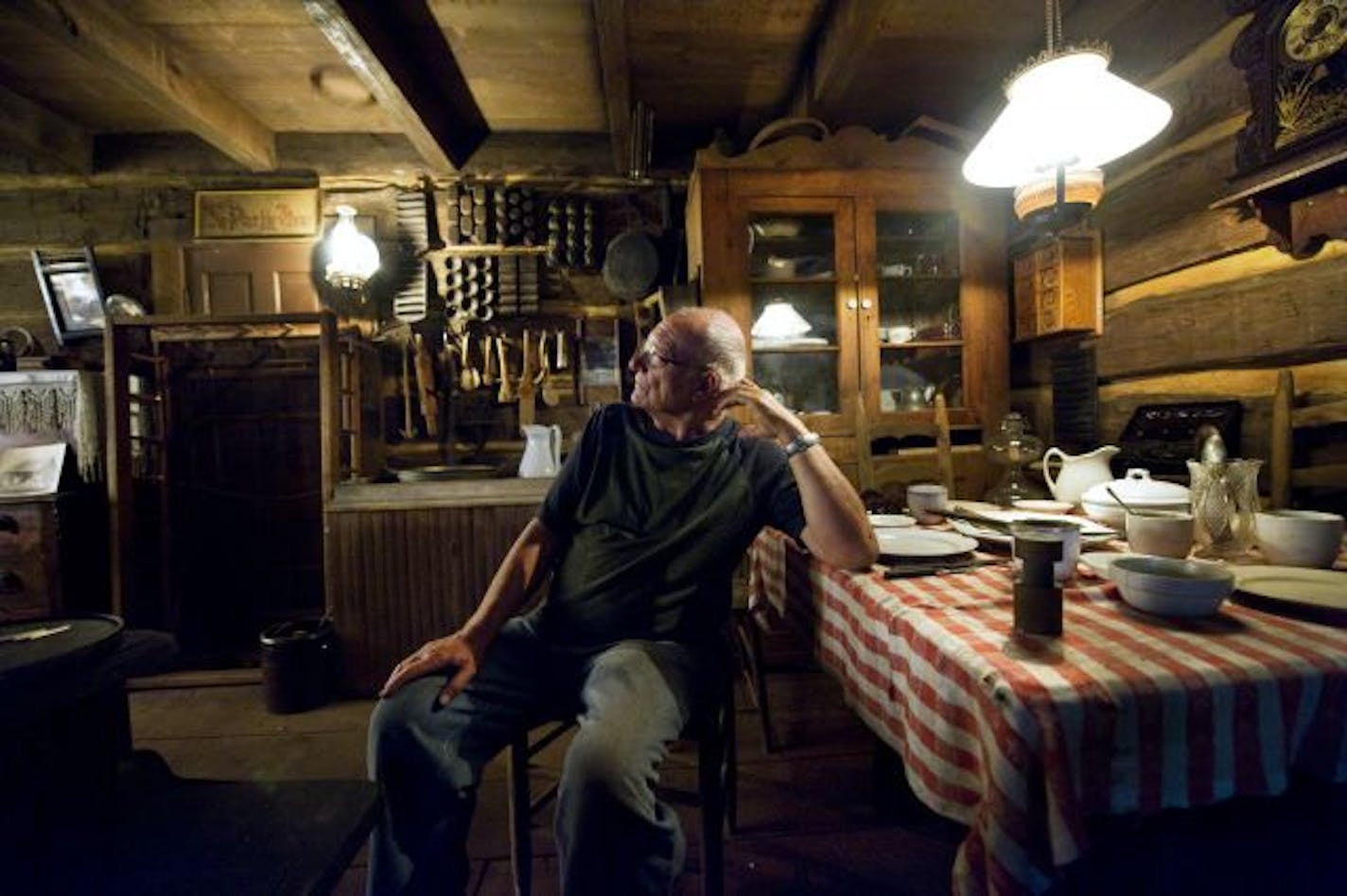 Collector Ron Wienhold restored this log cabin, lit by kerosene lamps