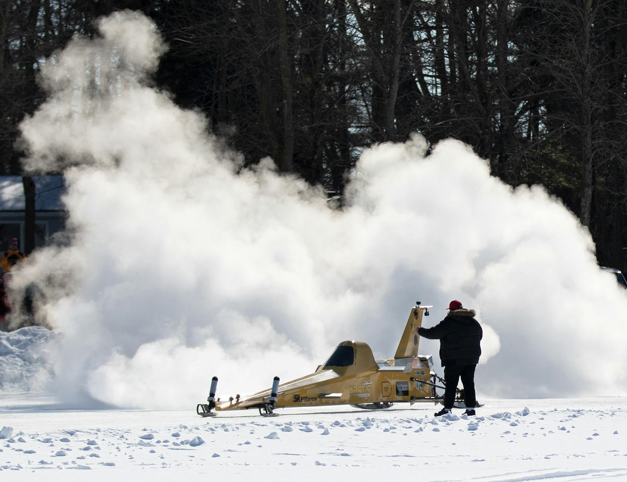 Kurt Anderson powers up the Arctic Arrow as Ky Michaelson runs through final safety checks before the Arrow's first launch on Sunday, Feb. 16, 2020 on Bear Lake in Manawa, WI.