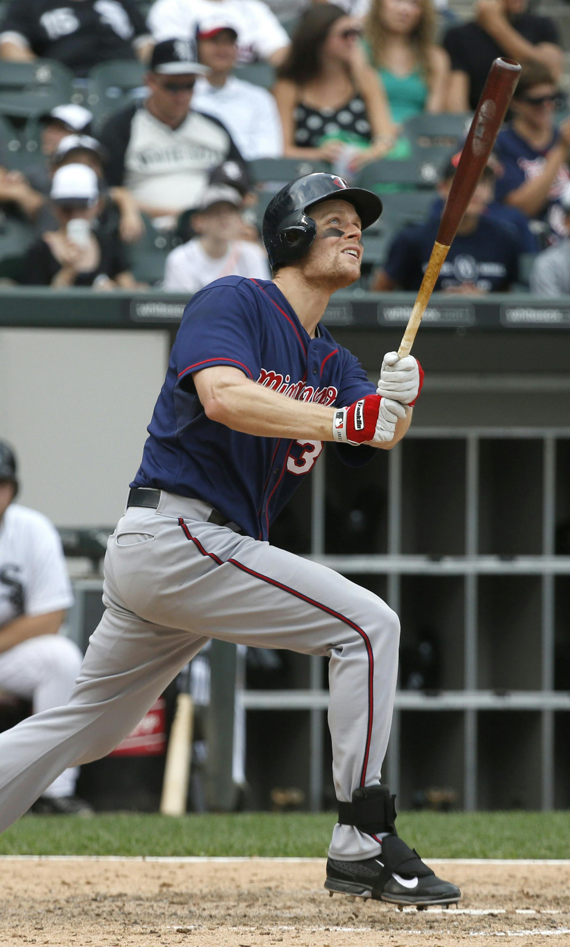 Minnesota Twins' Justin Morneau watches his home run off Chicago White Sox relief pitcher Ramon Troncoso during the ninth inning of a baseball game Friday, Aug. 9, 2013, in Chicago. (AP Photo/Charles Rex Arbogast)
