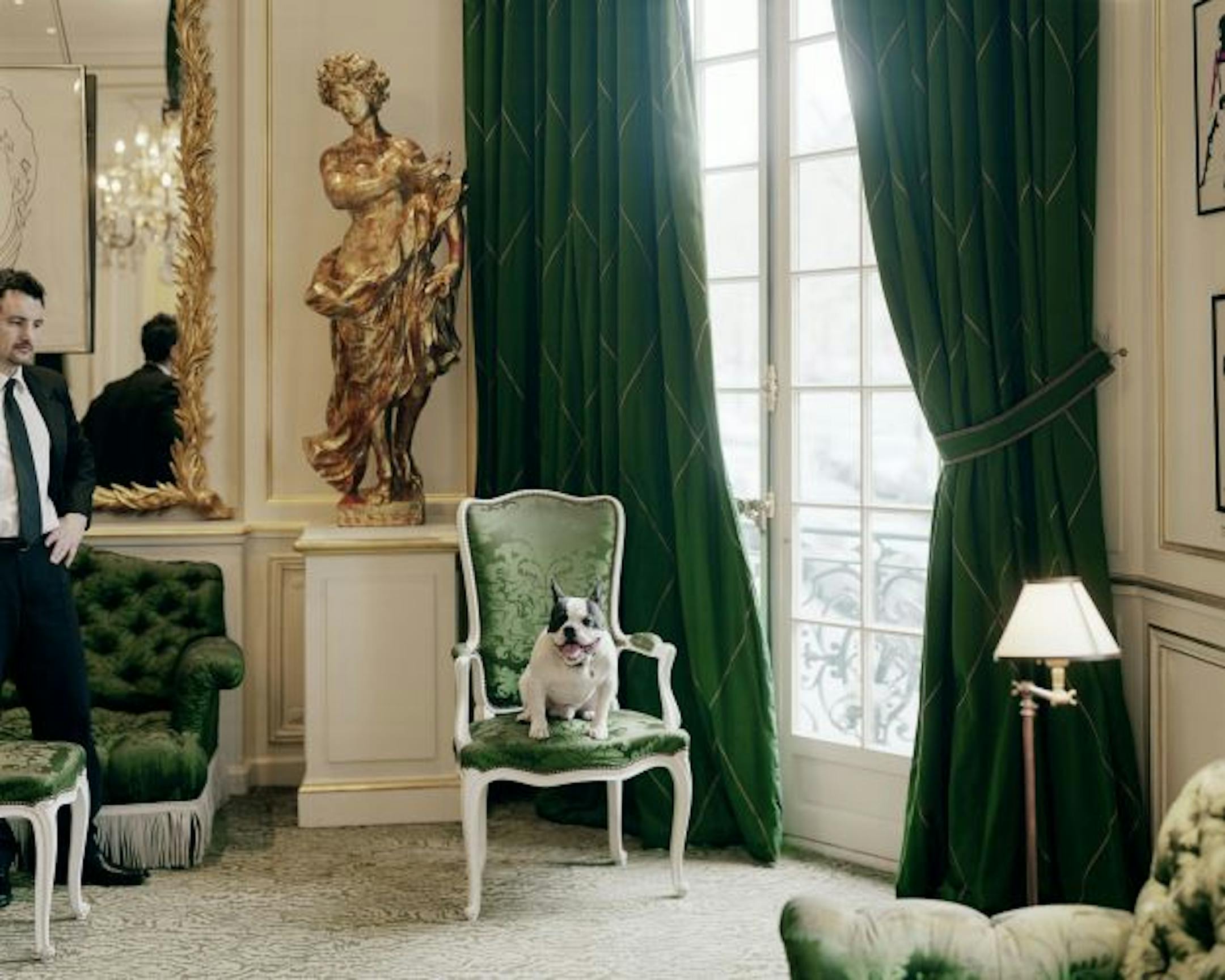 WEINSTEIN GALLERYAlec Soth photo: Yves Saint Laurent�s bulldog, �Moujik IV,� squatting on a green brocade chair under the watchful eye of his bodyguard