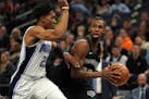 Minnesota Timberwolves forward Andrew Wiggins (22) looked to pass the ball around Orlando Magic forward Wesley Iwundu (25) in the first half.