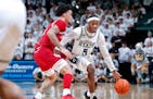 Tre Holloman, right, drove toward the basket against Indiana’s Jalen Hood-Schifino during during Tuesday’s 80-65 Spartans victory in East Lansing,