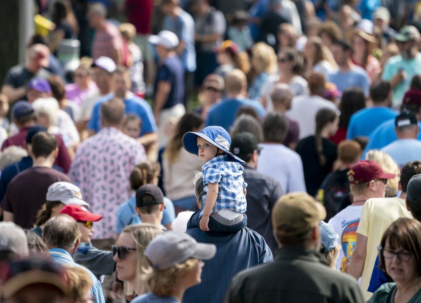 Eddie Hoeschen, 2, rode on his grandpa Kevin Hoeschen's, of Duluth, shoulders as they walked through a thick crowd at the Minnesota State Fair in Falcon Heights, Minn., on Friday, August 23, 2019.