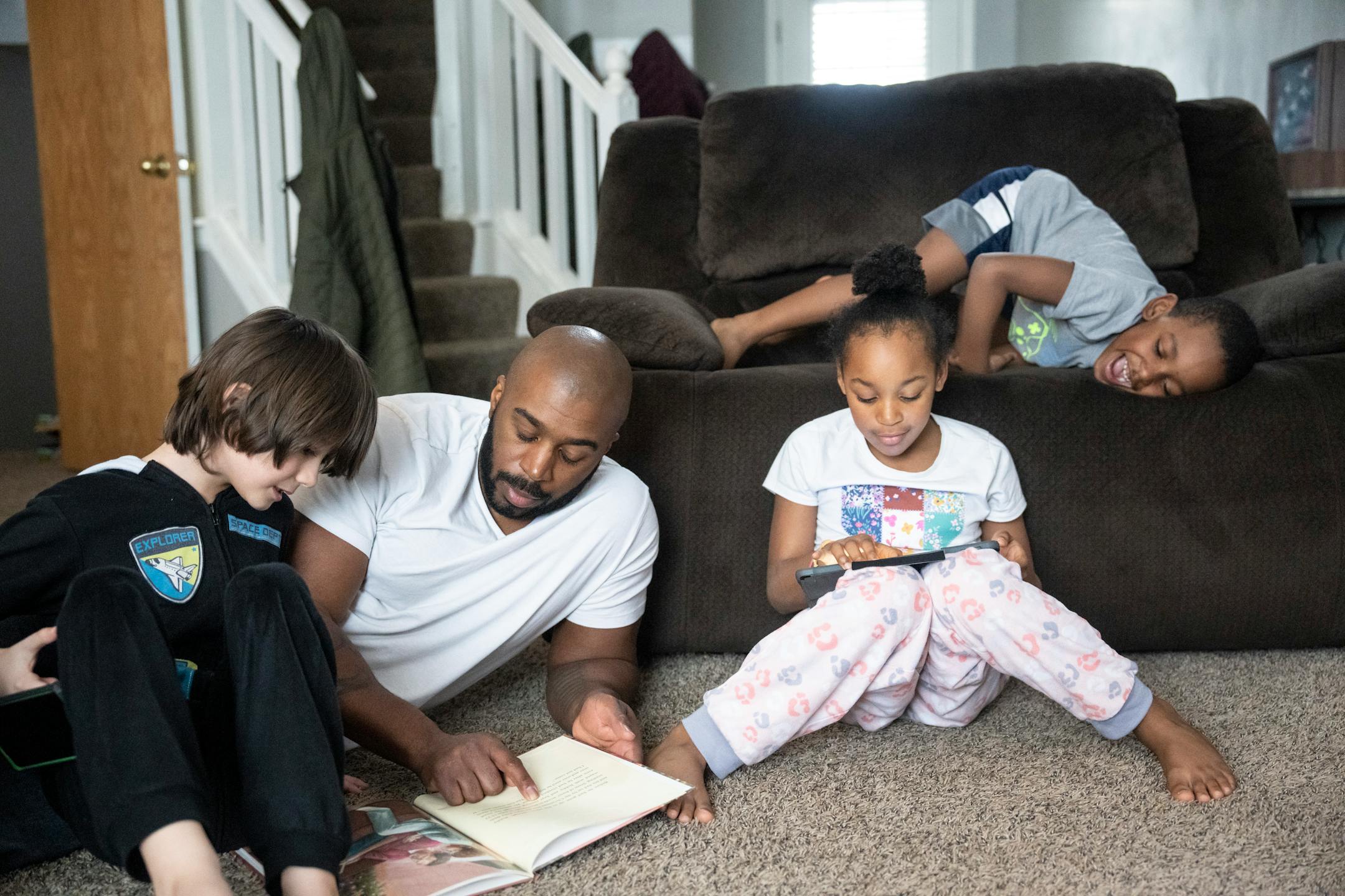 Deonté Haynes spends the day with his three younger children (from the left) Alex, 8, and Jalei, 8, and Deonté Jr., 6, after he took the day off from work so he could help with distance learning during the snow storm.