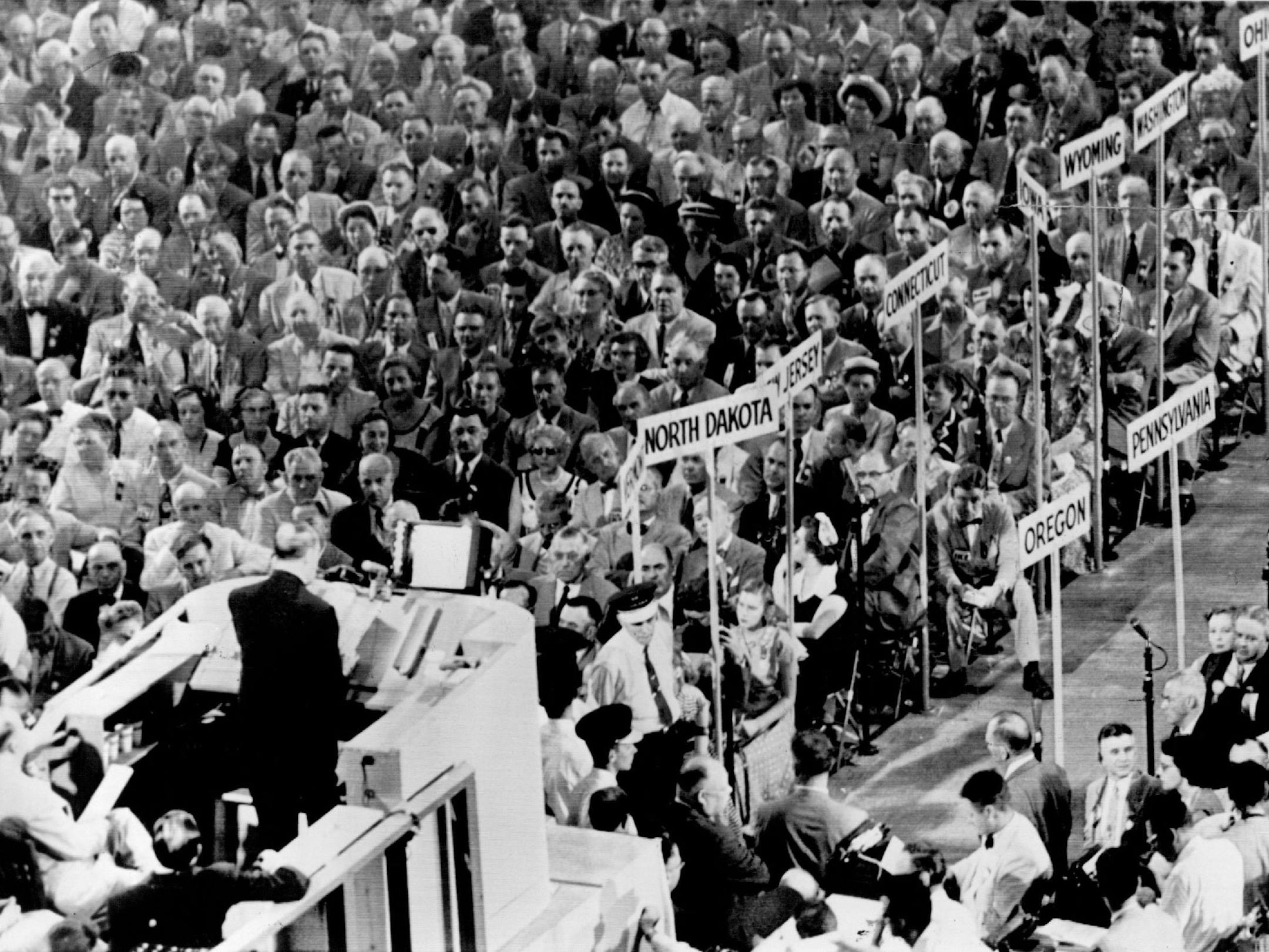 July 8, 1952 Front Row - North Dakota delegates are virtually at "ringside‚Äù in convention hall. They were part of the intent and serious audience up. front as Gen. Douglas MacArthur delivered his keynote address Monday night. The North Dakota banner can be seen just to the right of the speaker's stand. Minneapolis Star Tribune