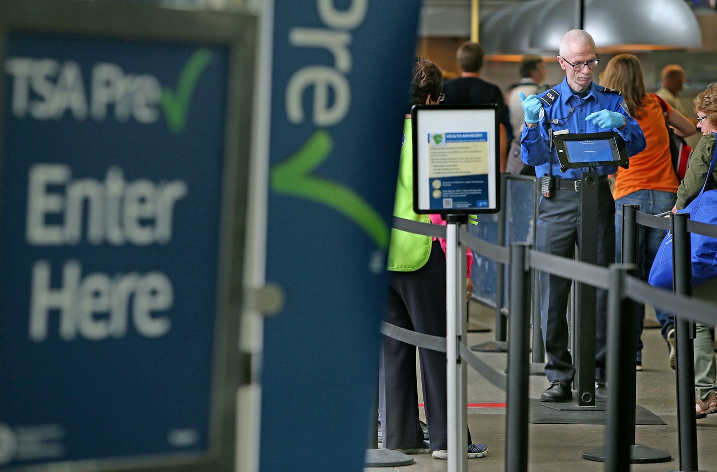 Passengers make their way through the TSA PreCheck area at Terminal 1 at Minneapolis-St. Paul International Airport.