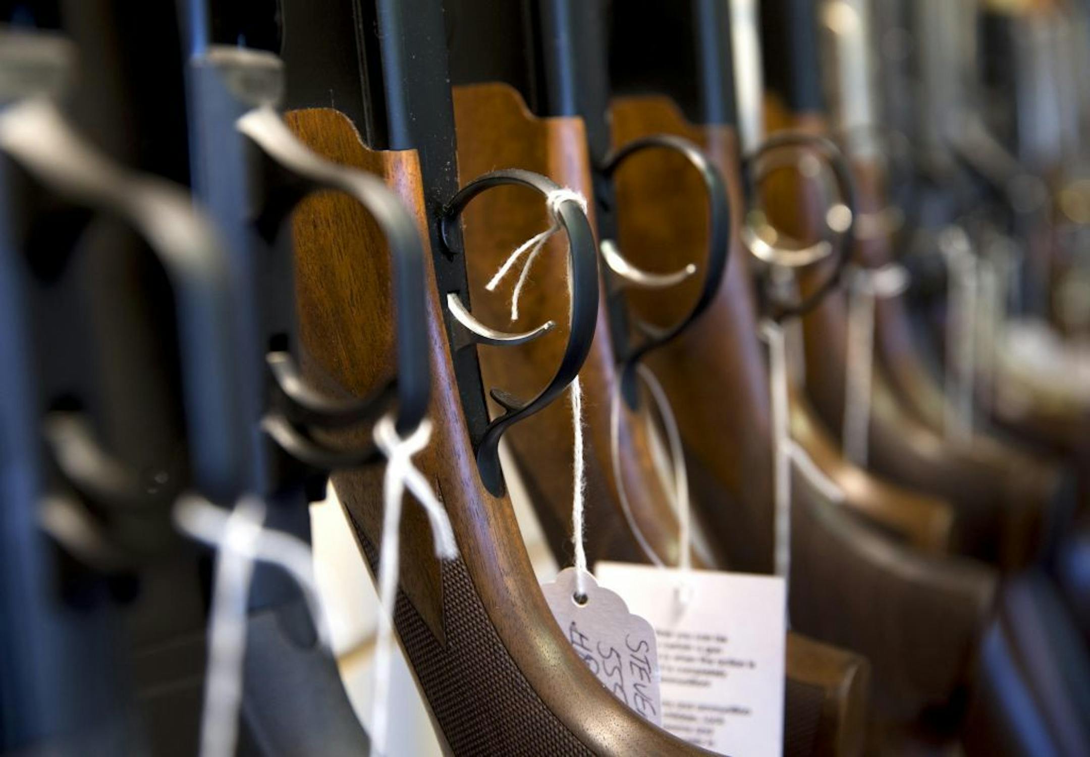 This Tuesday, Dec. 15, 2015 photo shows guns at Atlantic Outdoors in Stokesdale, N.C. Locally and across the nation, gun sales are spiking as the country continues to reel from repeated mass shooting in recent years.