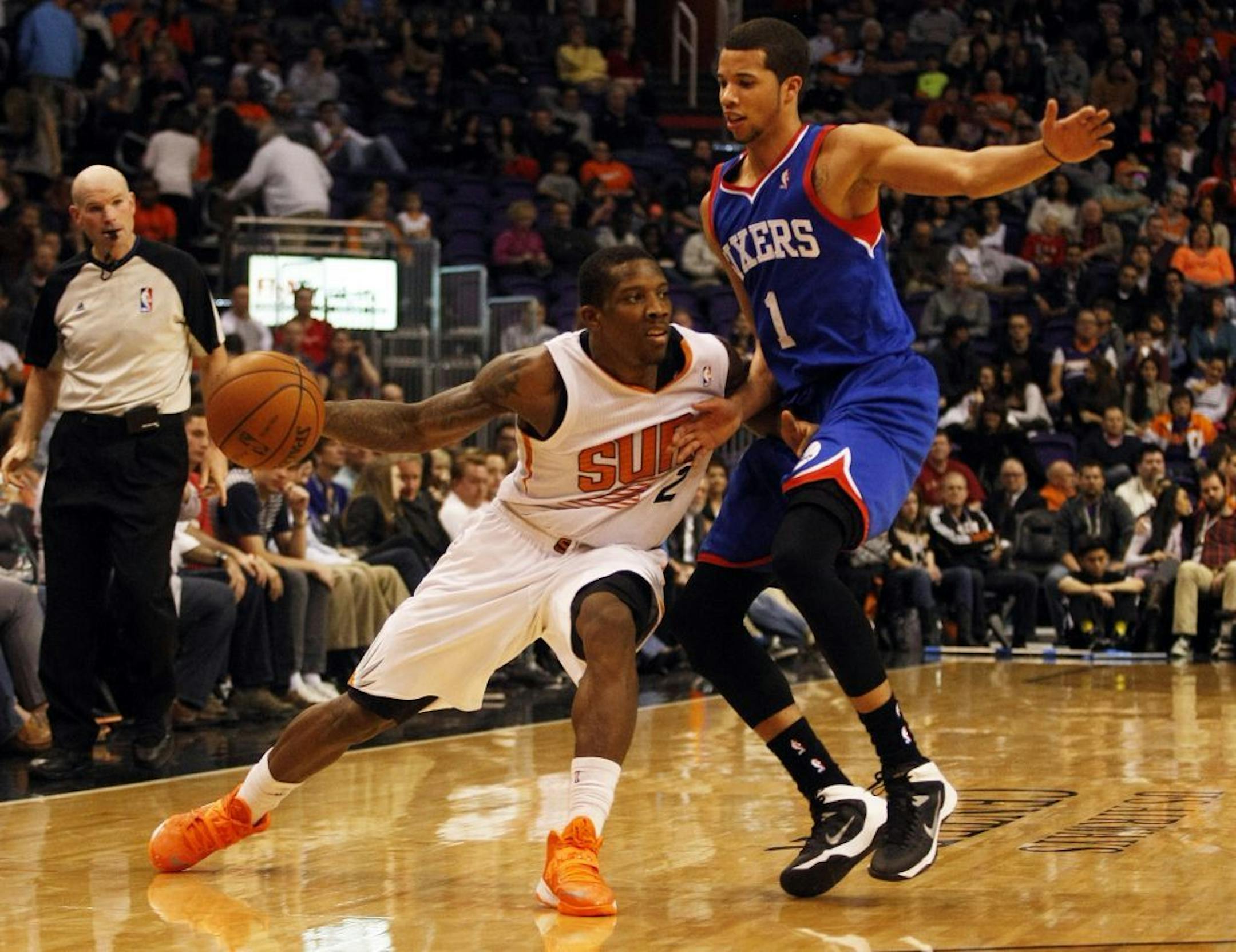 Phoenix Suns point guard Eric Bledsoe (2) shields Philadelphia 76ers point guard Michael Carter-Williams (1) from the ball in the third quarter during an NBA basketball game on Saturday, Dec. 28, 2013, in Phoenix.